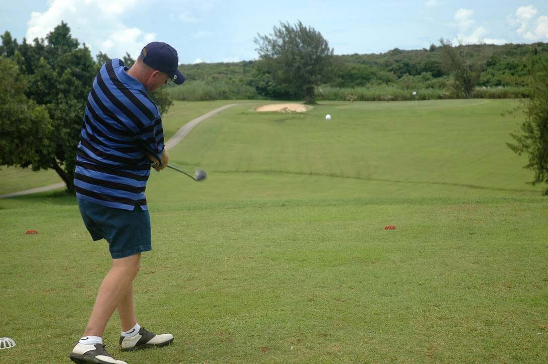 A Team Andersen member drives a ball during the Air Force 60th Anniversary Golf Tournament at the Admiral Nimitz Golf Course Sept. 7. More than 140 people participated in the event. (USAF Photo by Tech. Sgt. Michael Boquette)
