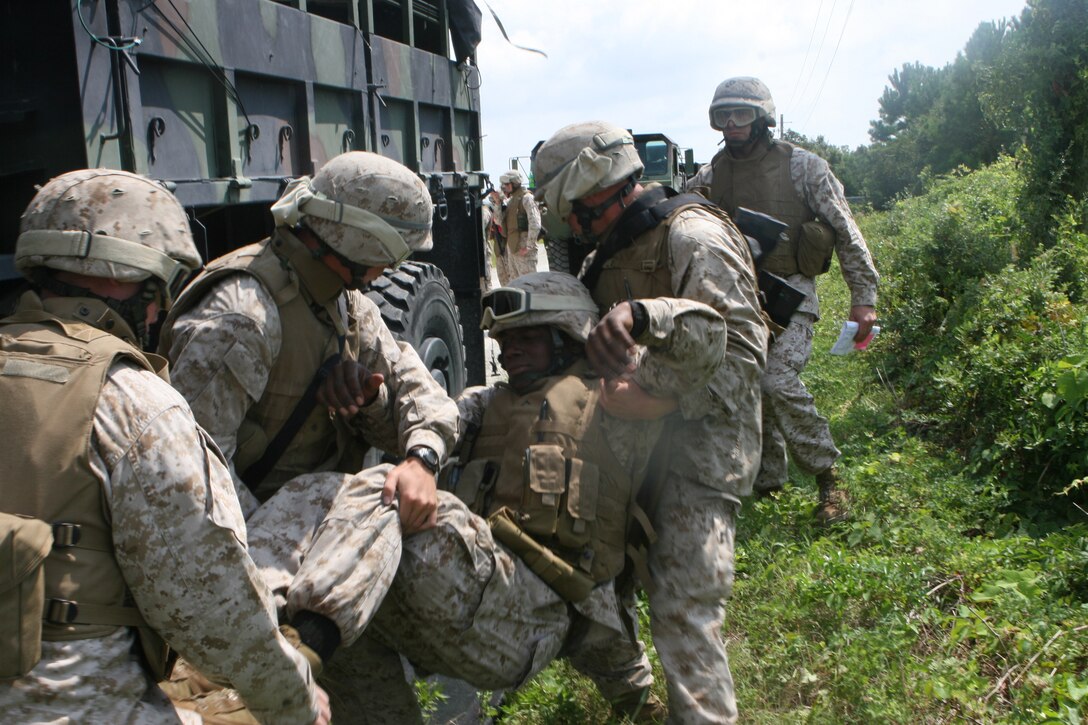 MARINE CORPS BASE CAMP LEJEUNE, N.C. ? Marines from Motor Transport Platoon, Headquarters and Service Company, 2nd Light Armored Reconnaissance Battalion, 2nd Marine Division, pull a simulated wounded Marine from a seven-ton truck during casualty-evacuation training here Sept. 13. The injured Marine will be flown from the scene in the newest aircraft for getting Marines onto and off of the battlefield, the MV-22 Osprey. For the Marines of the ?Destroyer? battalion, it was their first chance to train with the tilt-rotor aircraft.