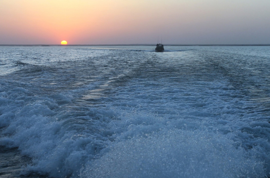 HADITHA DAM, Iraq, (Sept. 16, 2007) – A Riverine Patrol Boat with Riverine Squadron 1, Riverine Group 1, Navy Expeditionary Combat Command, in support of Regimental Combat Team 2, powers down the Euphrates River as the sun goes down. As the first deployed Navy riverine unit since the Vietnam War, the squadron had the responsibility to not only accomplish the mission, but to also pave the way for future riverine forces. Official Marine Corps Photo By Cpl. Ryan C. Heiser.
