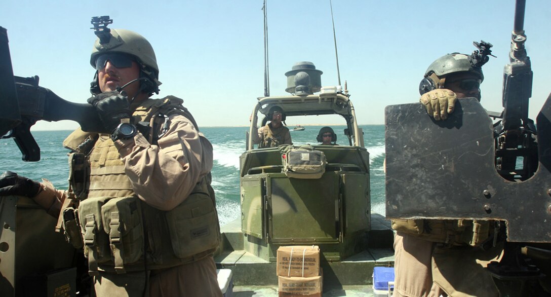 HADITHA DAM, Iraq, (Sept. 16, 2007) – Navy riverines with Detachment 1, Riverine Squadron 1, Riverine Group 1, Navy Expeditionary Combat Command man their machineguns during a patrol on the Euphrates River. The squadron was stood up, trained, and deployed in less than a year, and is the first Navy riverine unit to be deployed since the Vietnam War. Official Marine Corps Photo By Cpl. Ryan C. Heiser.