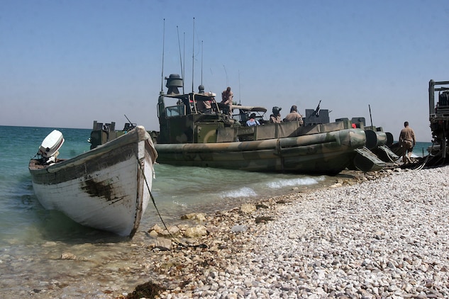 HADITHA DAM, Iraq, (Sept. 16, 2007) – An Iraqi civilian’s boat sits on the shore of the dam as sailors with Riverine Squadron 1, Riverine Group 1, Navy Expeditionary Combat Command, in support of Regimental Combat Team 2, prepare to leave on a patrol to enforce the temporary 24-hour curfew on the waterway. The riverines warned locals of the new curfew for several days before seizing the boats of repeat curfew offenders. Official Marine Corps Photo By Cpl. Ryan C. Heiser.