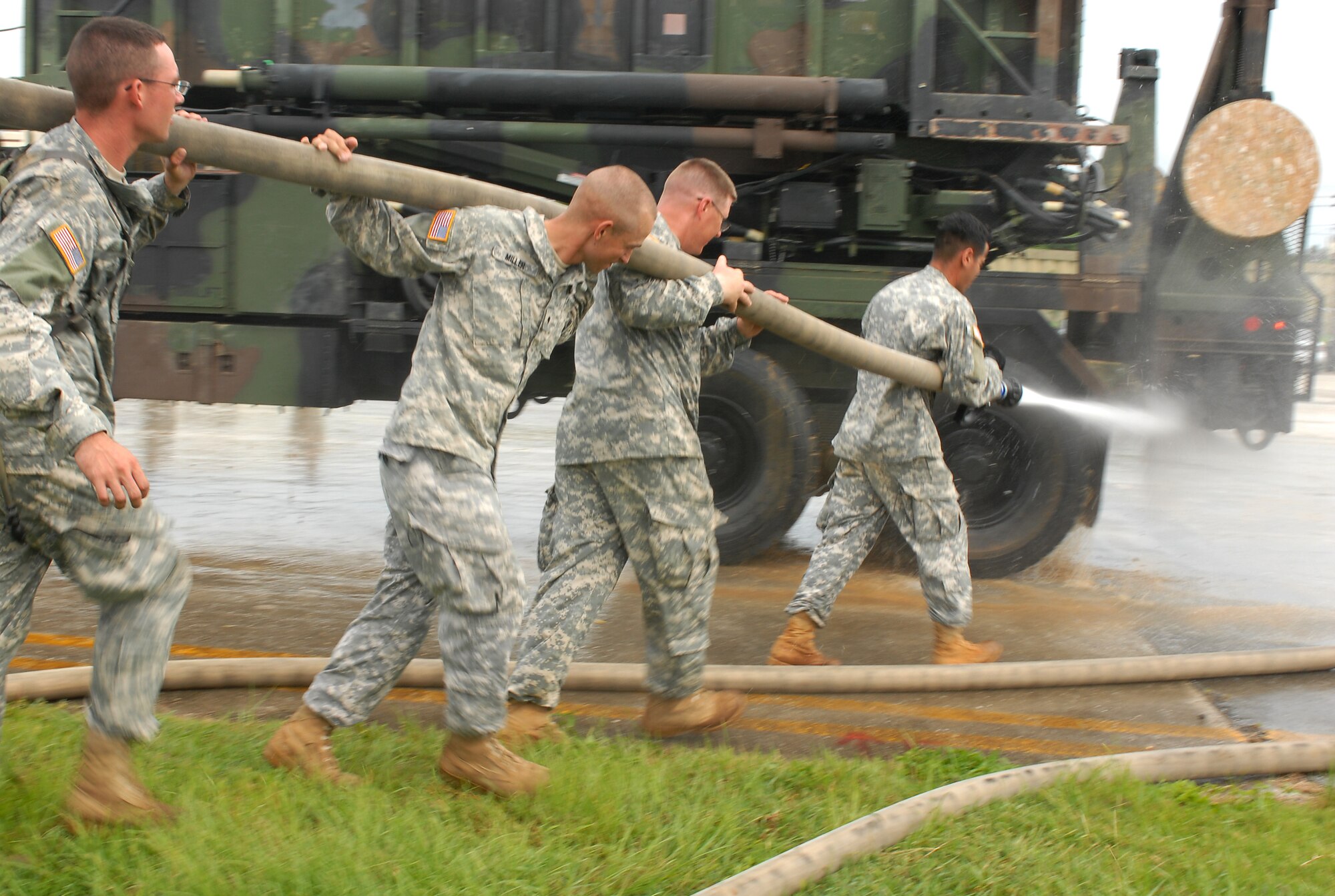 Solders from the 1-1 Air Defense Artillery Battalion hose down all their heavy equipment before they park them into a hanger to weather Typhoon Nari at Kadena Air Base, Japan, Sept. 14, 2007. The typhoon will hit the island the evening of Sept. 14 with 45 knot winds gusting to 65 knots. (U.S. Air Force photo/Airman 1st Class Kelly Timney)