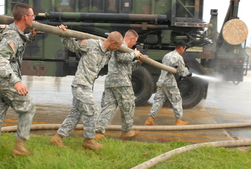 Solders from the 1-1 Air Defense Artillery Battalion hose down all their heavy equipment before they park them into a hanger to weather Typhoon Nari at Kadena Air Base, Japan, Sept. 14, 2007. The typhoon will hit the island the evening of Sept. 14 with 45 knot winds gusting to 65 knots. (U.S. Air Force photo/Airman 1st Class Kelly Timney)