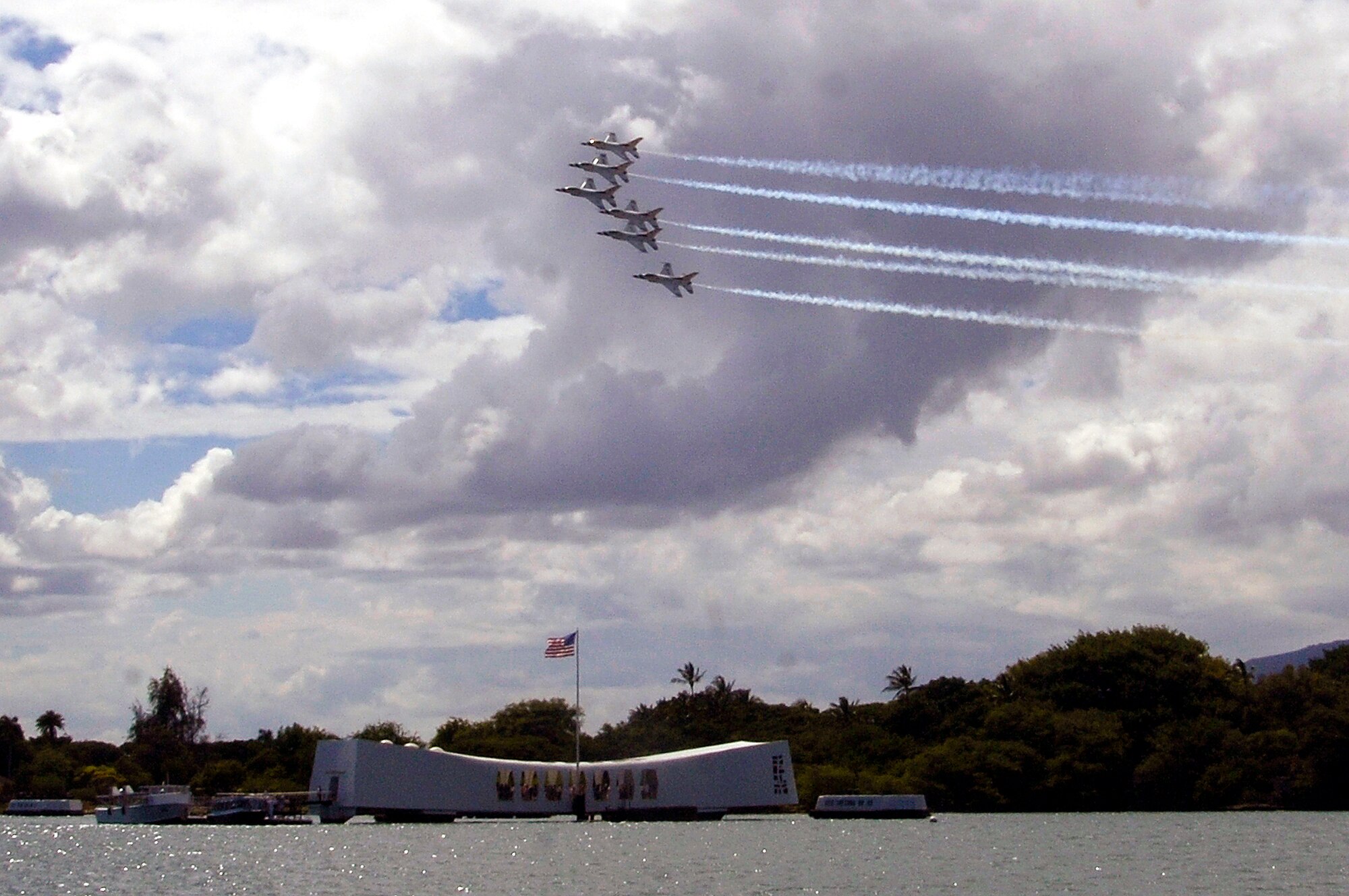 PEARL HARBOR -- The U.S. Air Force Air Demonstration Squadron Thunderbirds fly over the U.S.S. Missouri and the U.S.S. Arizona Memorial in Honolulu, Hawaii, on September 13, 2007. The Thunderbirds will be bringing the Air Force, its people and their capabilities to the residents of Hawaii during their air shows to commemorate the U.S. Air Force’s 60th Anniversary. (U.S. Air Force photo by Staff Sgt. Derrick C. Goode)