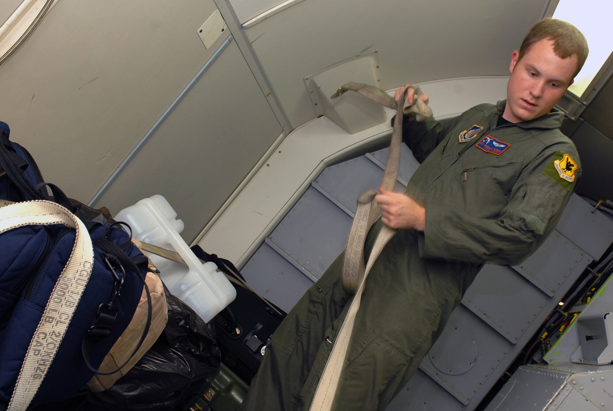 Senior Airman Michael Klouda secures baggage during the preflight inspection of the E-3 Airborne Warning and Control System (AWACS) before it takes off in support of the 18th Operations Group Turkey Shoot at Kadena Air Base, Japan,  Sept. 11, 2007.  The Turkey Shoot is an annual event where all squadrons compete against each other to determine who's the best in the wing.  Airman Klouda is from the 961st Airborne Air Control Squadron.  (U.S. Air Force photo/Airman 1st Class Kelly Timney)