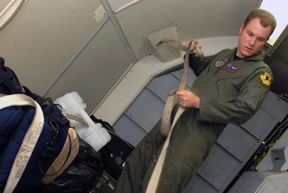 Senior Airman Michael Klouda secures baggage during the preflight inspection of the E-3 Airborne Warning and Control System (AWACS) before it takes off in support of the 18th Operations Group Turkey Shoot at Kadena Air Base, Japan,  Sept. 11, 2007.  The Turkey Shoot is an annual event where all squadrons compete against each other to determine who's the best in the wing.  Airman Klouda is from the 961st Airborne Air Control Squadron.  (U.S. Air Force photo/Airman 1st Class Kelly Timney)