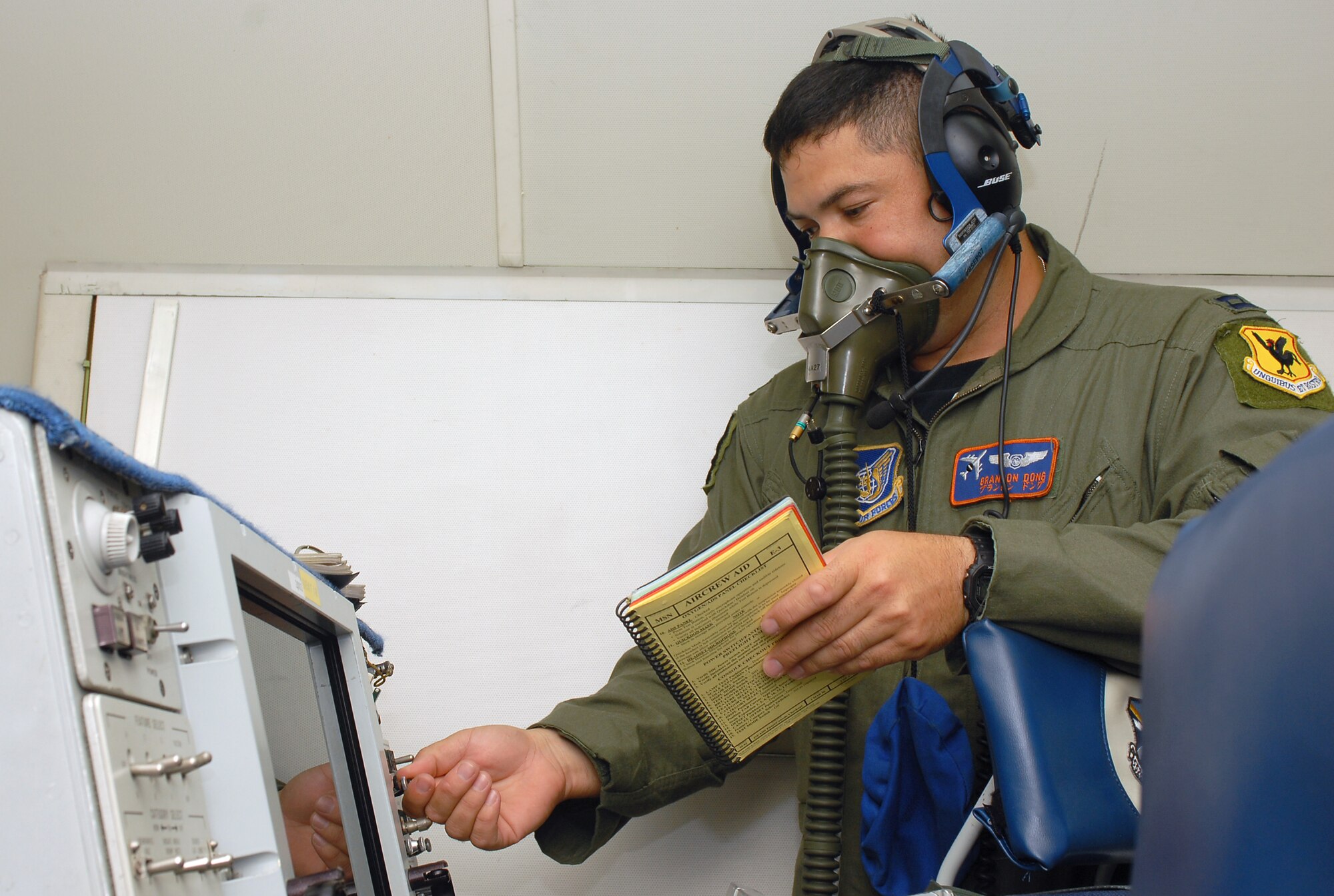 Capt. Brandon Dong tests his oxygen mask during the preflight inspection of the E-3 Airborne Warning and Control System (AWACS) before it takes off in support of the 18th Operations Group Turkey Shoot competition at Kadena Air Base, Japan, Sept. 11, 2007.  The Turkey Shoot is an annual event where all squadrons of the wing compete against each other to determine who's the best.  Captain Dong is from the 961st Airborne Air Control Squadron.  (U.S. Air Force photo/Airman 1st Class Kelly Timney)