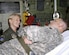 Lt. Col. Diana Copper talks with Army Staff Sgt. Walter J. McMaster inside an air medical evacuation configured C-130 aircraft prior to being transported to the next medical facility.