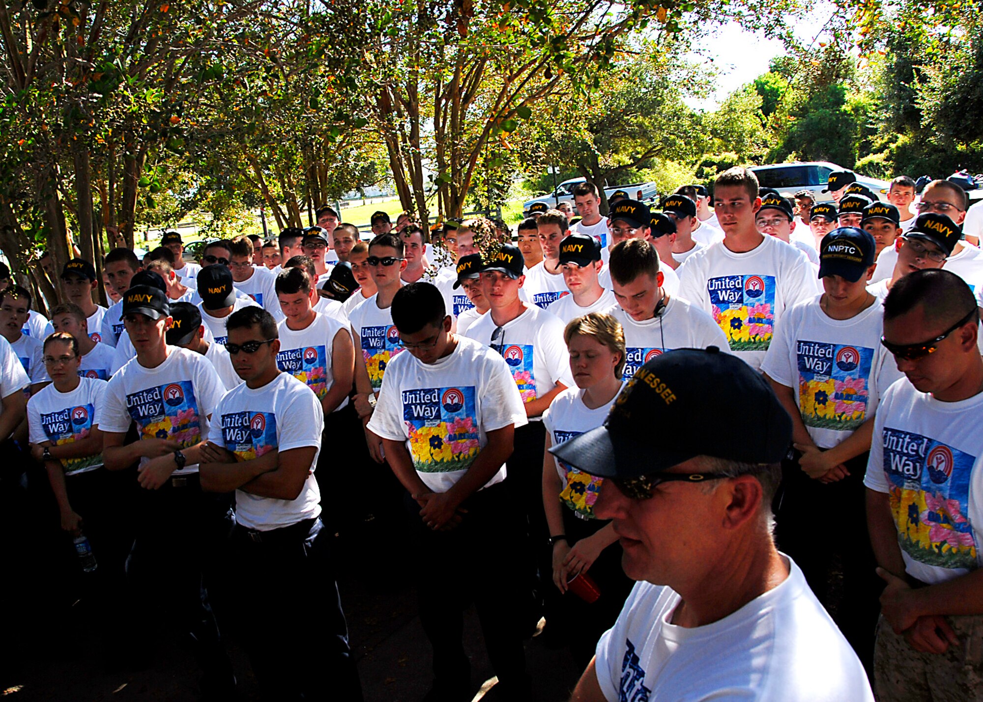 Military volunteers from Team Charleston and the Navy Nuclear Power Training Command pray before receiving a meal at the end of the United Way's Day of Caring 2007. (photo by Capt. Chett Collier, USAFR)