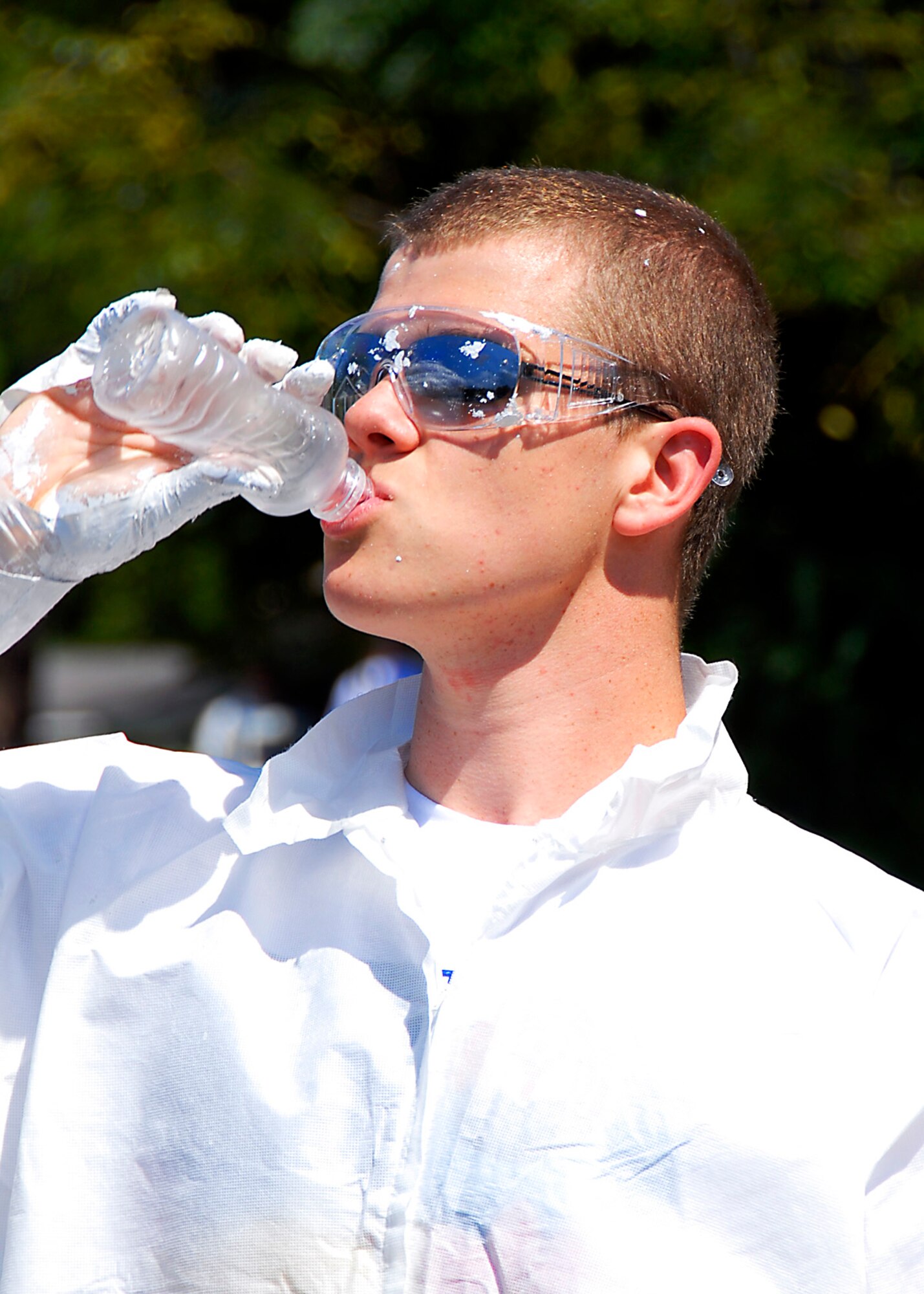 A student from the Naval Nuclear Power School cools off with a cold drink after painting a home in the Rosemount neighborhood while volunteering with the United Way's Day of Caring. (photo by Capt. Chett Collier, USAFR)