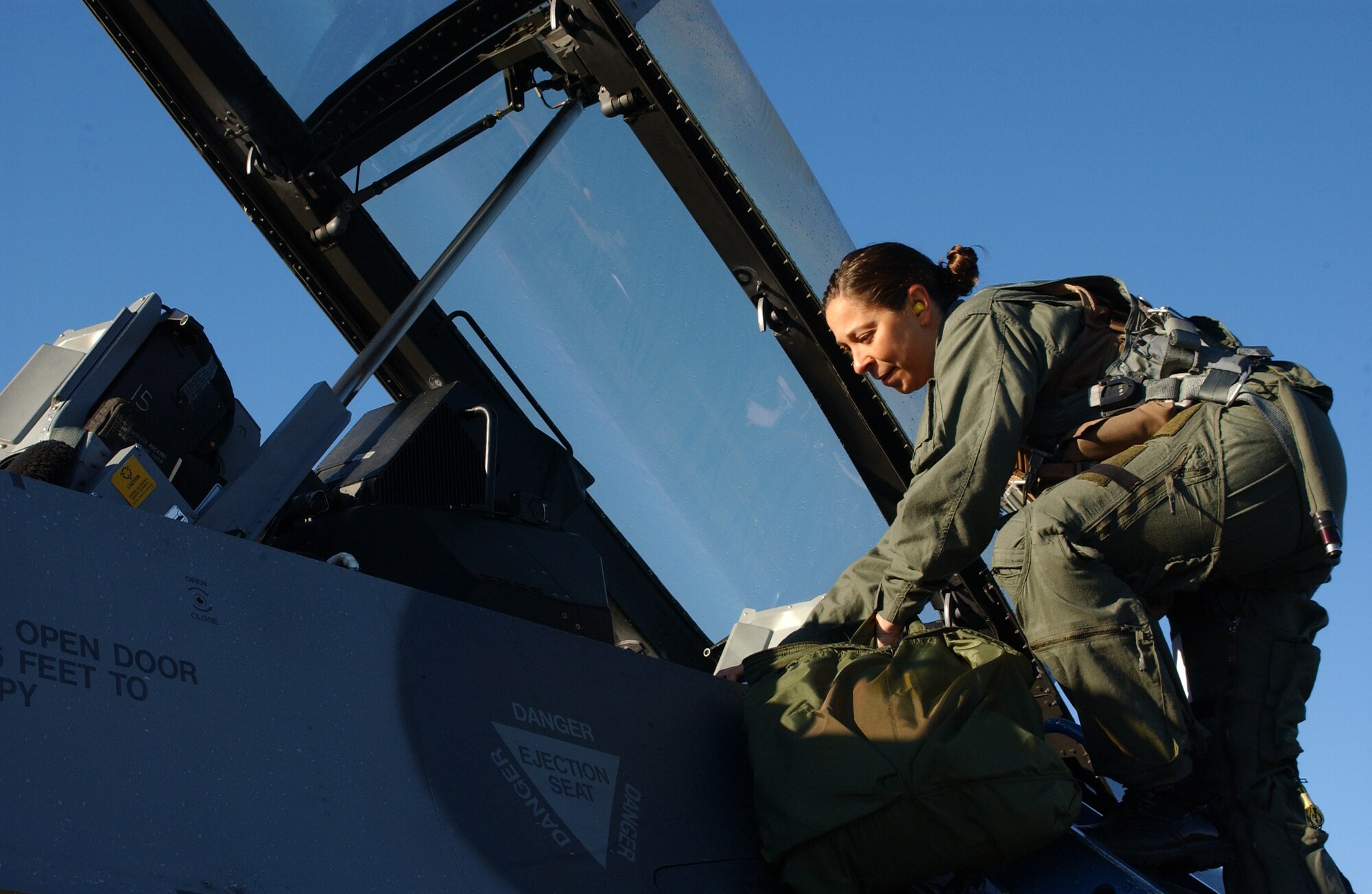 EIELSON AIR FORCE BASE, Alaska--Master Sgt. Deanna Croxen, Eielson Airman Leadership School instructor, climbs into the cockpit for her F-16 incentive ride Sept. 13. The incentive program's purpose is for group commanders to acknowledge the hard work and dedication of their Airmen. (U.S. Air Force photo by Airman 1st Class Nora Anton)                               