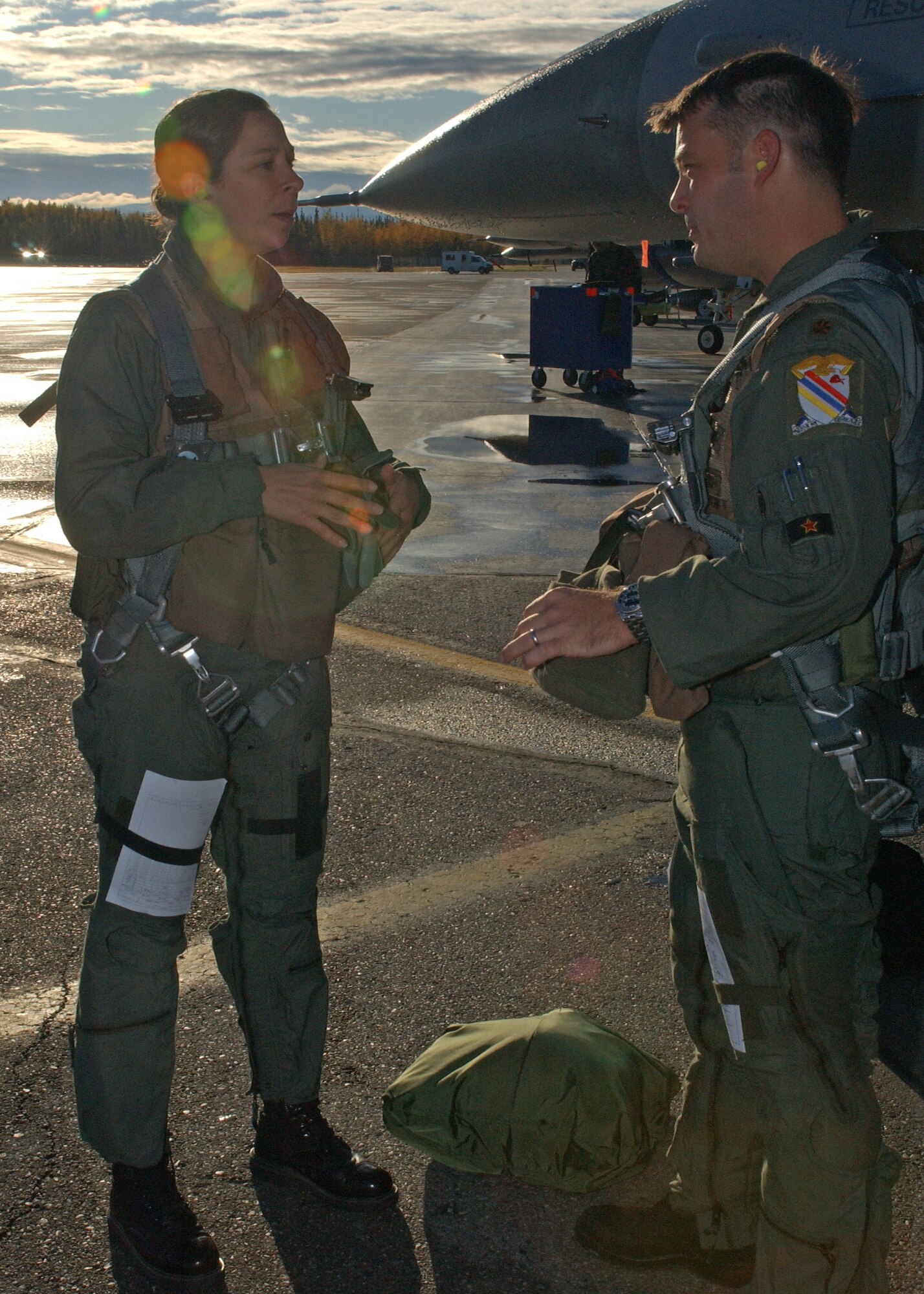 EIELSON AIR FORCE BASE, Alaska--Maj. Norman Johnsen, 354th Operations Support Squadron F-16 pilot, gives Master Sgt. Deanna Croxen, Eielson Airman Leadership School instructor, a pre-flight briefing before her F-16 incentive ride Sept. 13. The incentive program's purpose is for group commanders to acknowledge the hard work and dedication of their Airmen. (U.S. Air Force photo by Airman 1st Class Nora Anton)                                        
