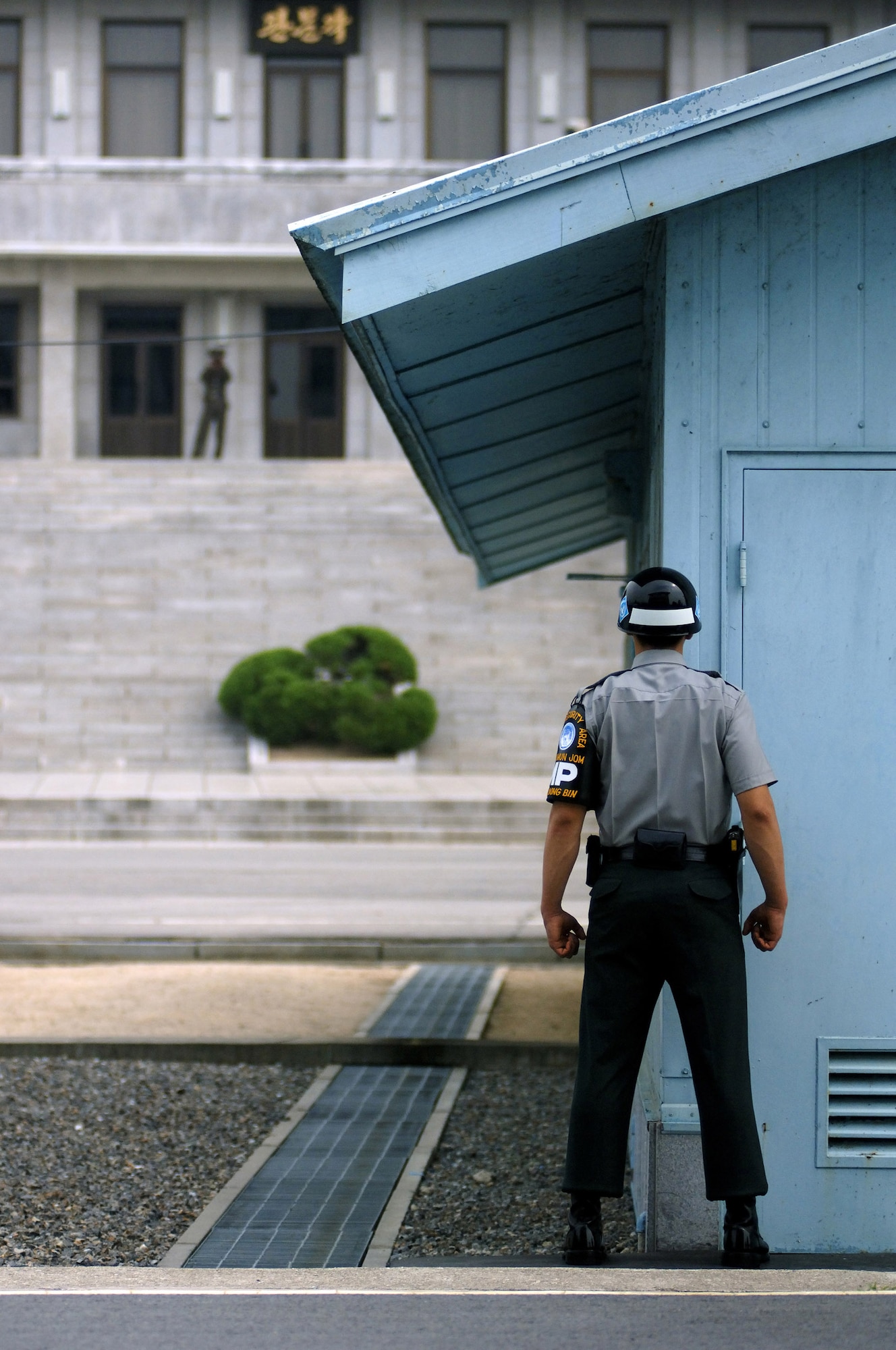 A South Korean military policeman stands guard inside the Korean Demilitarized Zone during a Sept. 13 tour held to honor Korean War veterans in Panmunjeom, South Korea. The joint security area is the only place where North and South Korea connect. Air Force Korean War veterans are visiting South Korea during a weeklong tour in observance of the Air Force's 60th Anniversary. (U.S. Air Force photo/Staff Sgt. Bennie J. Davis III) 
