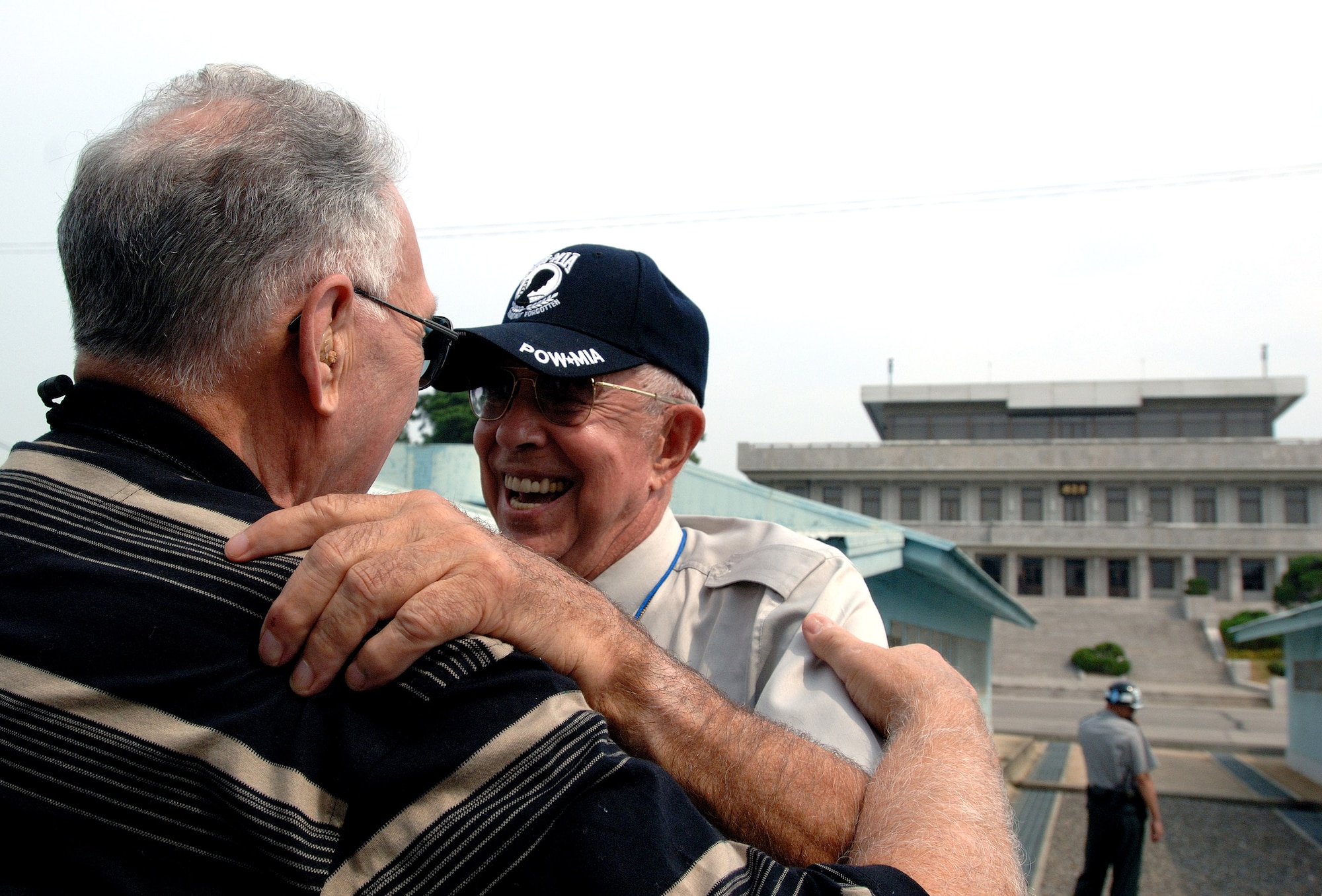 Donald Krueger (left) hugs retired Lt. Col. Harold Fischer after meeting by chance during a visit to the Korean Demilitarized Zone during a Sept. 13 tour held to honor Korean War veterans in Panmunjeom, South Korea. Colonel Fischer is a double ace fighter pilot from the war. Mr. Krueger was an enlisted munitions specialist during the Korean War. The two had not seen each other in 55 years.  Air Force Korean War veterans were visiting South Korea during a weeklong tour in observance of the Air Force's 60th Anniversary. (U.S. Air Force photo/Staff Sgt. Bennie J. Davis III) 
