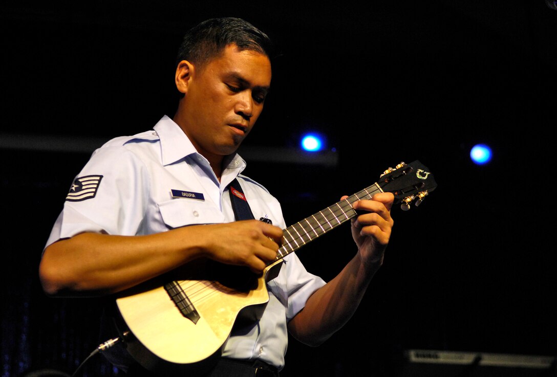 Tech. Sgt. Daniel Baduria plays his ukulele during an opening act for Tops In Blue at the Waikiki Shell Sept. 12. in Honolulu. TSgt. Baduria, an aircraft fuel systems specialist with the Hawaii Air National Guard’s 154th Wing paid a tribute to his father the late AIrman Donald Baduria who played ukulele and bass in "The Blue Notes " as part of the Tops In Blue entertainment showcase in 1956 and 1957.  (U.S. Air Force photo/Tech. Sgt. Shane A. Cuomo)

