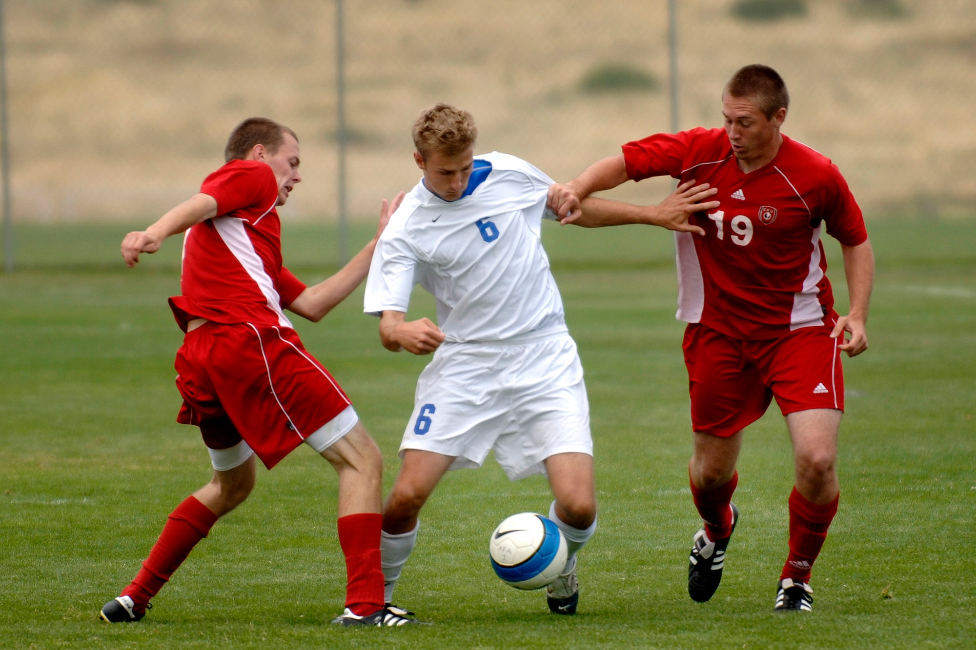 Senior Ian Hauck dribbles the ball through two defenders as Air Force posts its second consecutive shutout with a 1-0 victory over St. Francis University in men's soccer action Sept. 9 at the U.S. Air Force Academy Cadet Soccer Stadium in Colorado Springs, Colo. With the victory, Air Force improved to 2-2 this season, while St. Francis fell to 1-3. (U.S. Air Force photo/Mike Kaplan)