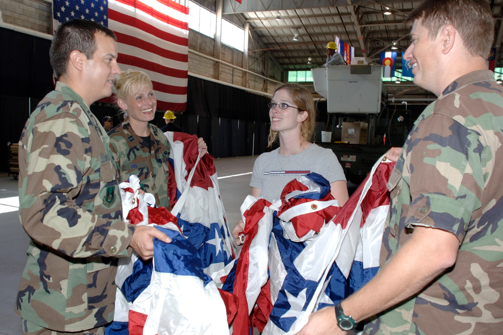 HANSCOM AFB, Mass. -- From left, Capt. Boone Spencer, 653rd Electronic Systems Group, Capt. Danielle Dee, 753 ELSG, Linda Whitmore, 66th Services Squadron, and Capt. Aaron Lake, Electronic Systems Center Legal Office, prepare to hang flag drapery in the Aero Club Hangar Sept. 12 in preparation for the Air Force 60th Anniversary Ball, which will be held Sept. 14. 

The Air Force became an independent service on Sept. 18, 1947. For more information on the Air Force 60th Anniversary, visit www.af.mil/library/usaf60.asp. (U.S. Air Force photo by Jan Abate)