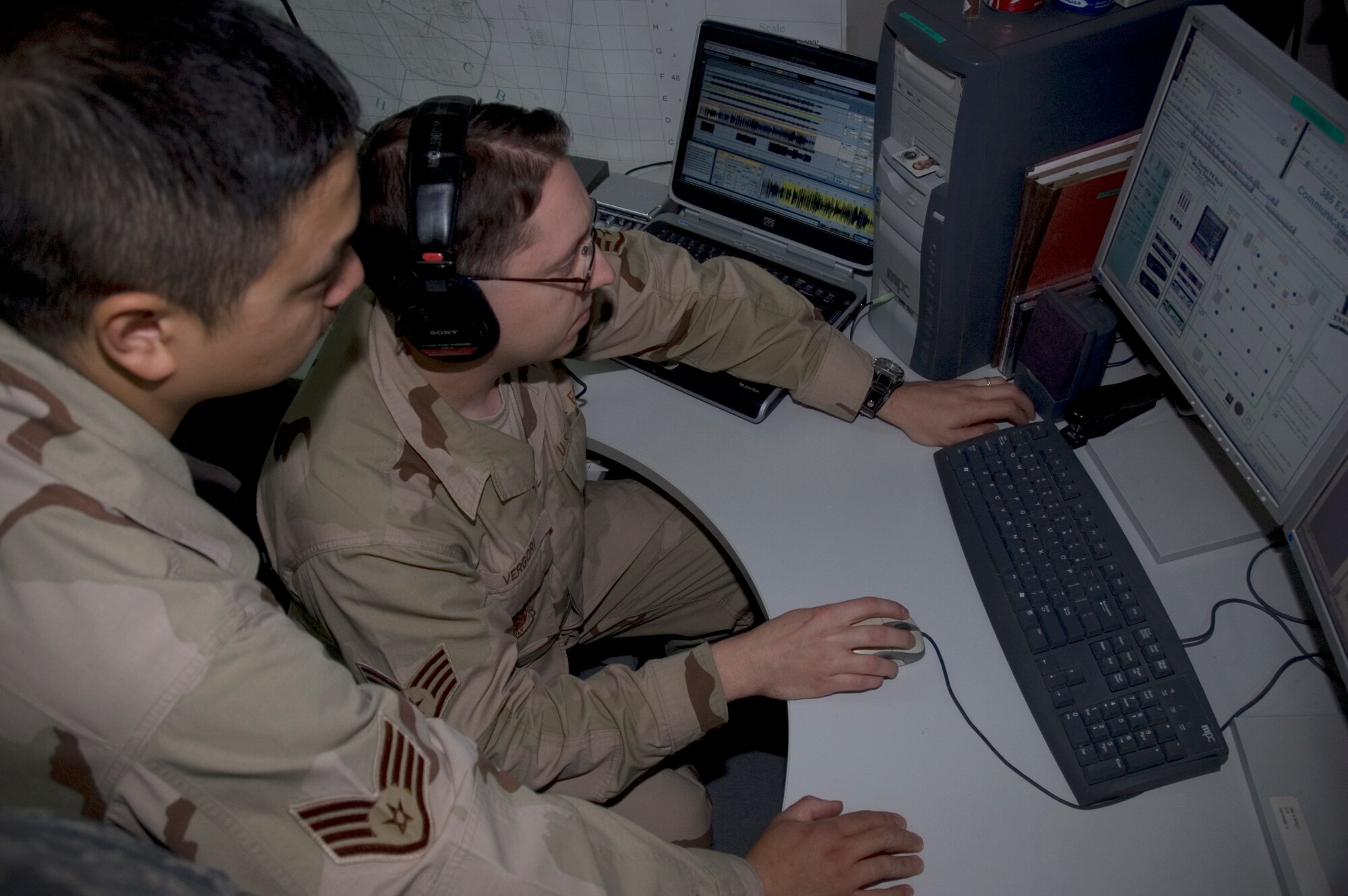 SOUTHWEST ASIA -- Staff Sgt John Lontoc and Staff Sgt Timothy Vergori perform post production maintenance on an audio editing system here on September 13.  Sgt Vergori is the NCOIC of ground mobile radio and visual imagery intrusion detection system (VIIDS) and deployed from Robbins Air Force Base, GA, and Sgt. Vergoni is a VIIDS technician deployed from Spangdahlem Air Base, Germany.  Both are assigned to the 386th Expeditionary Communications Squadron.  (U.S. Air Force photo by Staff Sgt. Tia Schroeder)