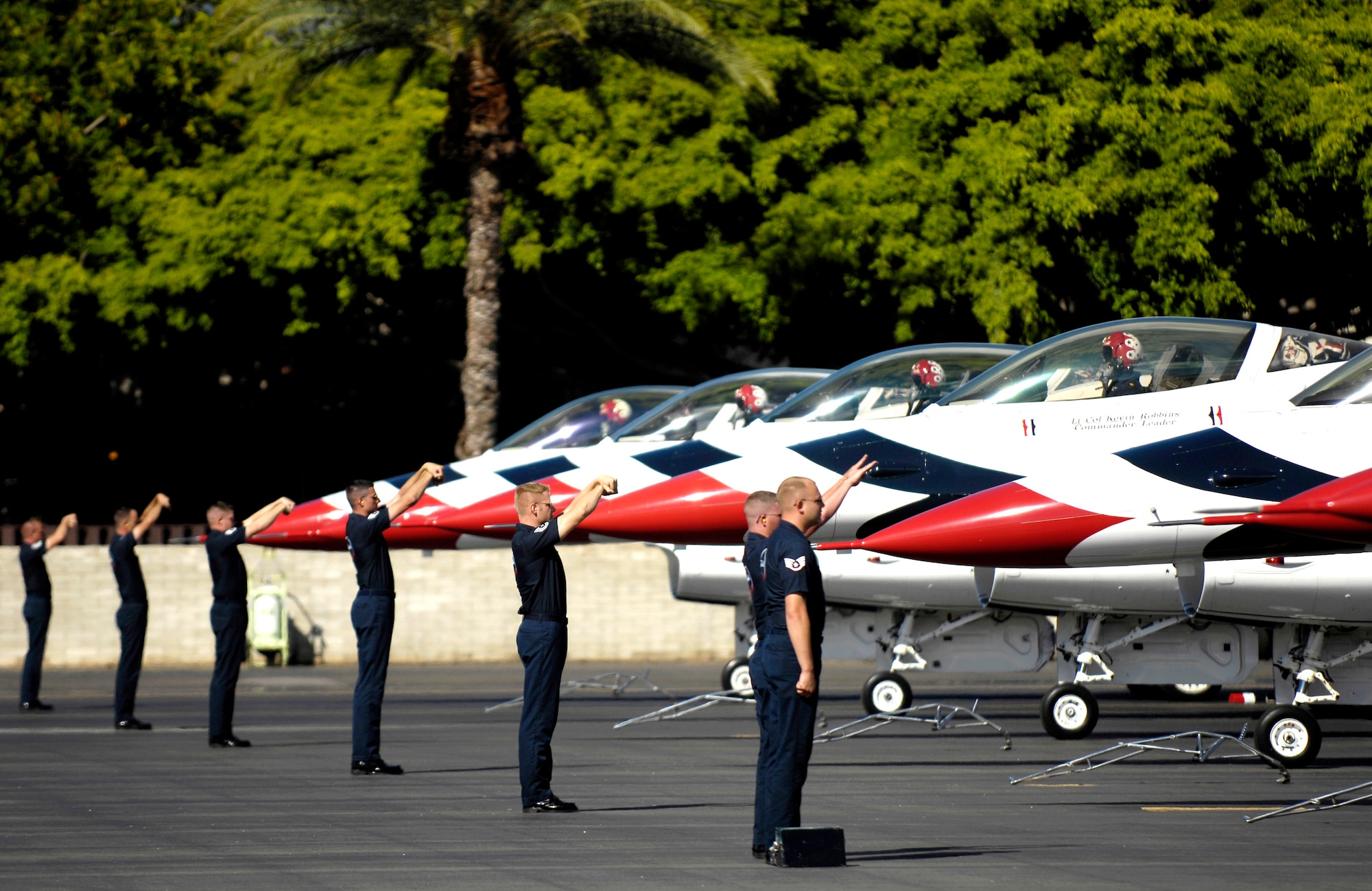 Thunderbird maintainers marshal F-16 Fighting Falcons to parking spots during an arrival ceremony Sept. 12 at Hickam Air Force Base, Hawaii. The Thunderbirds, the U.S. Air Force Air Demonstration Squadron, are performing as part of Air Force Week Honolulu, which runs Sept. 8 through 15. (U.S. Air Force photo/Tech. Sgt. Shane A. Cuomo) 
