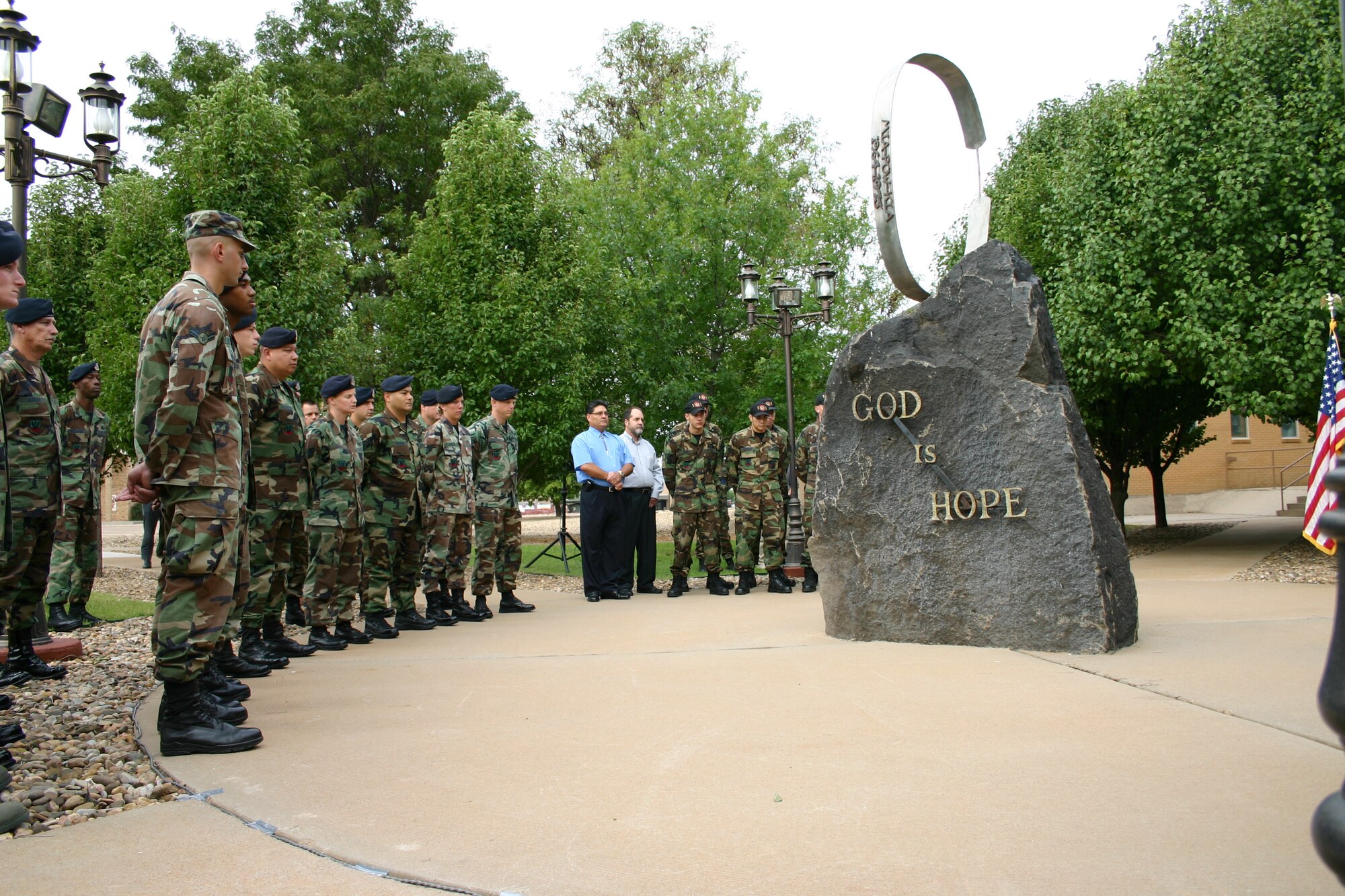 CANNON AIR FORCE BASE, N.M. -- Airmen and civilians from Cannon Air Force Base stand in memoriam to the victims of 9/11 during a memorial ceremony. The ceremony was held at the memorial park behind the base chapel Tuesday morning.(U.S. Air Force photo by Airman Elliott Sprehe)