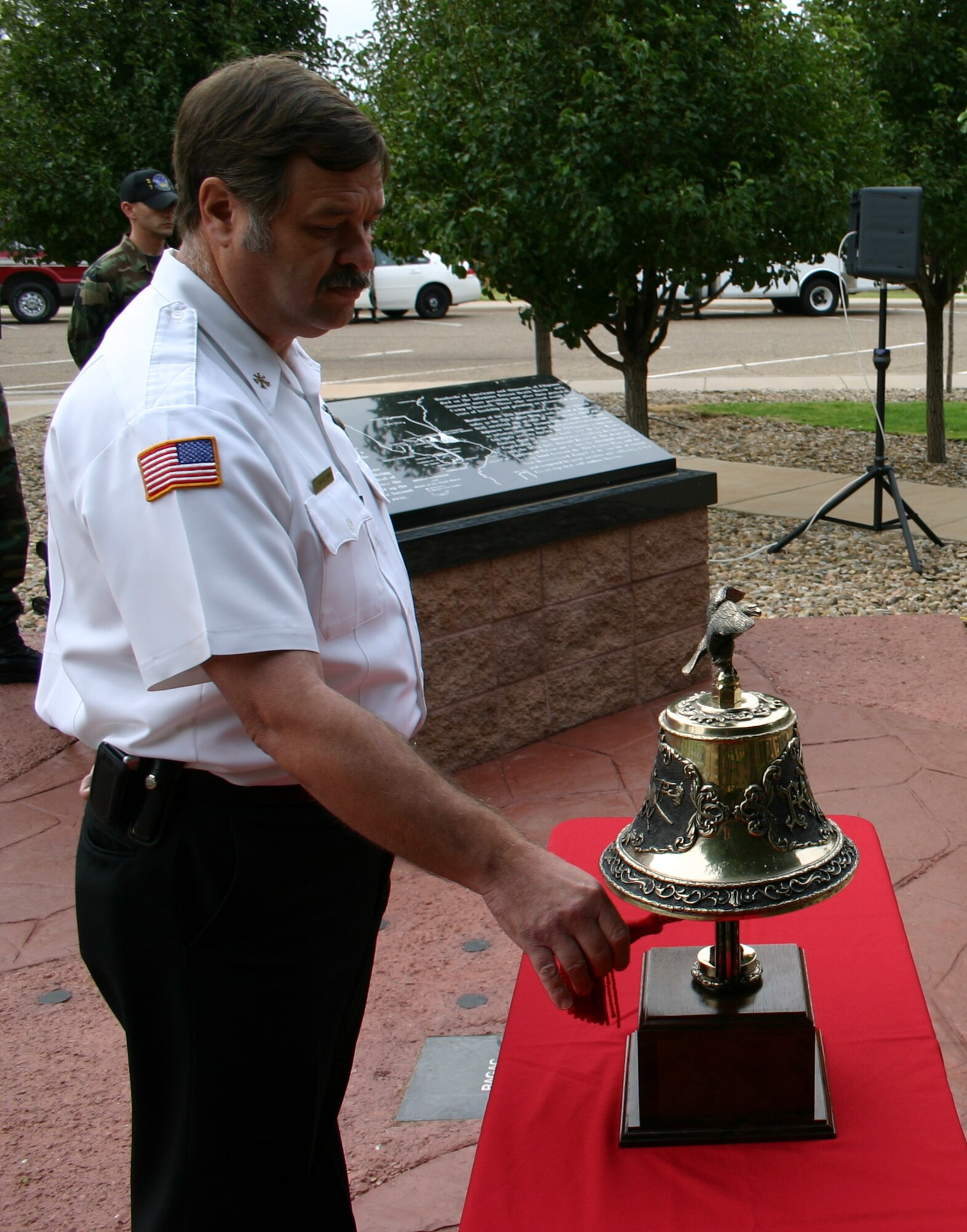 Bruce Ford, 27th Civil Engineering Squadron, sounds the bell in memorial of the victims of 9/11. The ceremony was held at the memorial park behind the base chapel Tuesday morning.(U.S. Air Force photo by Airman Elliott Sprehe)