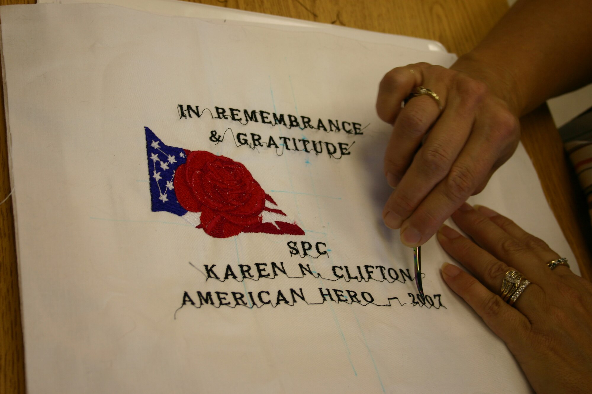 Linda Roberts removes excess stitches during a meeting of Operation Homefront Quilts. The national group makes quilts for family members of deceased servicemembers. (U.S. Air Force photo by Airman Elliott Sprehe)