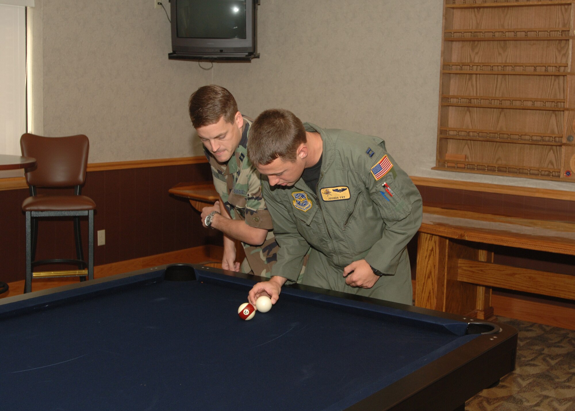 Capt. Jamison Braun, 319th Mission Support and Services Squadron, and Capt. Joshua Fry, 906th Air Refueling Squadron, celebrate the opening of the new Crud table with a quick game of Crud at Grand Forks AFB, North Dakota on September 5,  2007. (U.S. Air Force photo/Airman 1st. Class Chad Kellum)