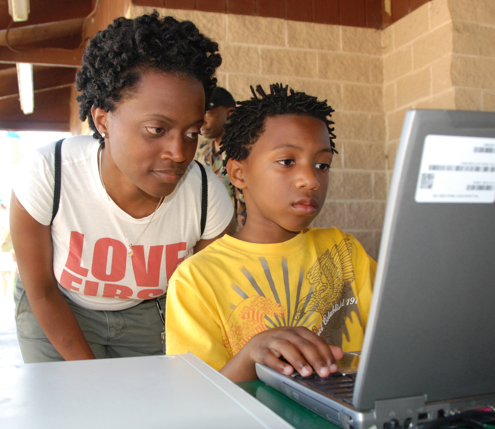 SEYMOUR JOHNSON AIR FORCE BASE, N.C--Master Sgt. Dot McAdams, of the 916th Air Refueling Wing legal office, keeps a watchful eye on what computer games are played by her son during the September Family Day Picinic that was held on the Saturday of the unit training assembly.