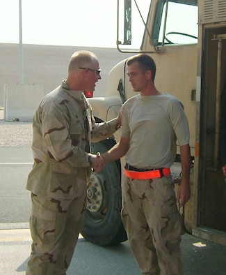 MISAWA AIR BASE, Japan -- Senior Airman Justin Neal, deployed from the 35th Logistics Readiness Squadron, is is presented with a coin for excellence from Lt. Col. Robert Hoff, 379th Expeditionary Logistics Readiness Squadron commander. Airman Neal recieved the coin for breaking the record for most fuel pumped in one month at his deployed location in Southwest Asia. He pumped 2.1 million gallons of fuel. In recognition of his efforts, a 2.1 million gallon fuel tank was named "Tank Neal." 