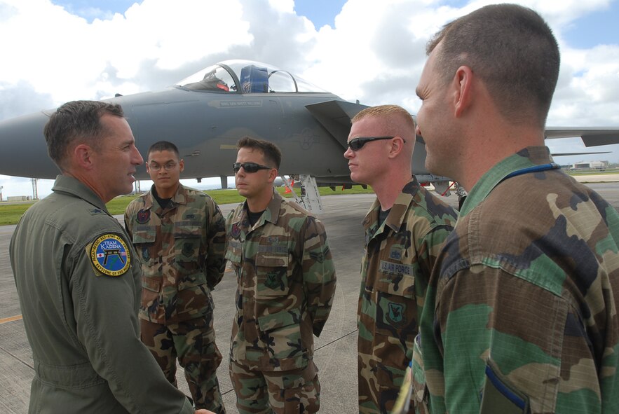 Brig. Gen. Brett Williams speaks with Airman Mauricio Agueros, Airman 1st Class Cody Waller, Staff Sgt. Kirk Smith, and Master Sgt. David Wade  during a visit to his dedicated crew chiefs at Kadena Air Base, Japan, Sept. 12, 2007.  The general is the 18th Wing commander and all four Airmen are dedicated crew chiefs with the 18th Aircraft Maintenance Squadron 44th Aircraft Maintenance Unit. (U.S. Air Force Photo/Senior Airman Darnell T. Cannady) 