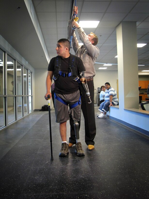 Army National Guard Spc. Marco Robledo is hooked into the harness of the Solo-Step system, which allows him to practice walking independently without danger of falling. The track is a one-of-a-kind system only at the new Military Advanced Training Center at Walter Reed Army Medical Center. The $10 million, 31-000-square-foot facility opened Sept. 23, 2007. Photo by Fred W. Baker III