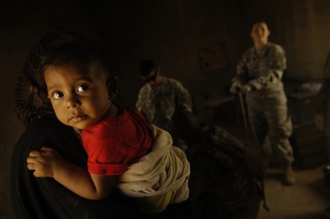 An Iraqi child waits for medical care from U.S. Army soldiers in Yusafiyah, Iraq, on Sept. 7, 2007.  The soldiers provided medical assistance, clothing, and toys to over 300 Iraqi citizens in an area once overtaken by Al-Qaeda operatives.  