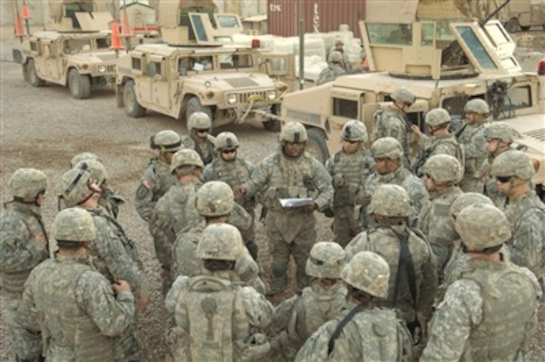 U.S. Army soldiers with Bravo Battery, 2nd Battalion, 32nd Field Artillery Regiment, 2nd Brigade Combat Team, 1st Infantry Division, receive a mission brief at Joint Security Station Torch in Baghdad, Iraq, Sept. 5, 2007.