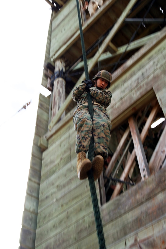 MARINE CORPS BASE HAWAII -- Cpl. Joseph Rhee, perssonel manpower clerk, G-1, U.S. Marine Corps Forces Pacific, fast ropes from the Marine Corps Base Hawaii repel tower Sept. 14, during the G-1s day of training and military education that focused on the stories of the prisoners of war during the Vietnam War era.   (Official USMC Photo by Cpl. R. Drew Hendricks)