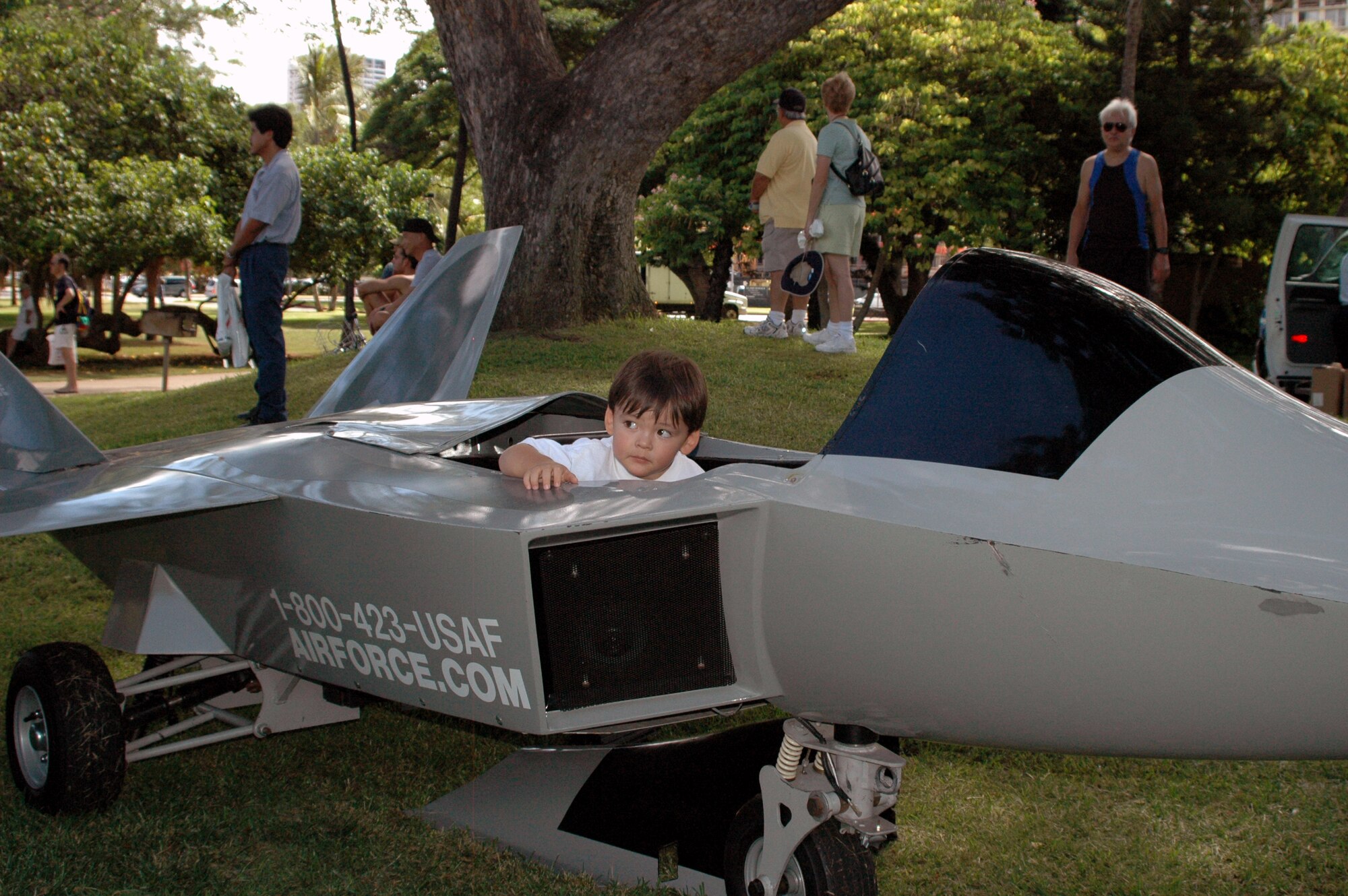 FORT DERUSSY, Hawaii -- Kellen Murphy, 2, tests out the Air Force recruiter’s F-22 mini jet Sept 13 at Fort DeRussy. The recruiters also brought two Thunderbird mini jets and gave the children rides. (U.S. Air Force photo by Tech. Sgt. Bryan Gatewood)