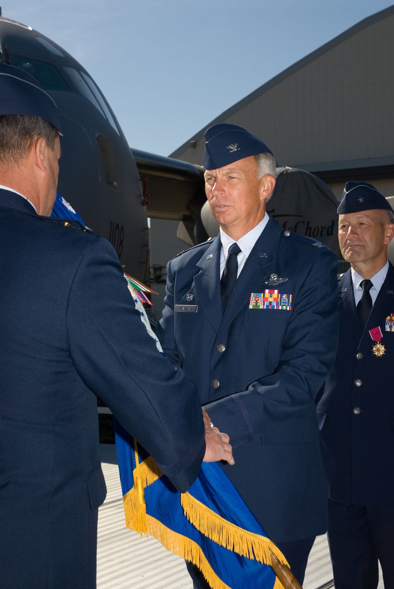 The new 446th Airlift Wing commander, Col. William Flanigan, accepts the wing's flag during the change of command ceremony Sept. 9 at McChord Air Force Base, Wash.  Colonel Flanigan last served as commander of the 939th Air Refueling Wing, Portland, Ore.  Brig. Gen. Eric Crabtree, outgoing 446th AW commander, will take command of the Air Reserve Personnel Center, Denver, Colo., where he will oversee personnel issues of Guard and Reserve Airmen. (U.S. Air Force photo/Tech. Sgt. Eli Yamzon)