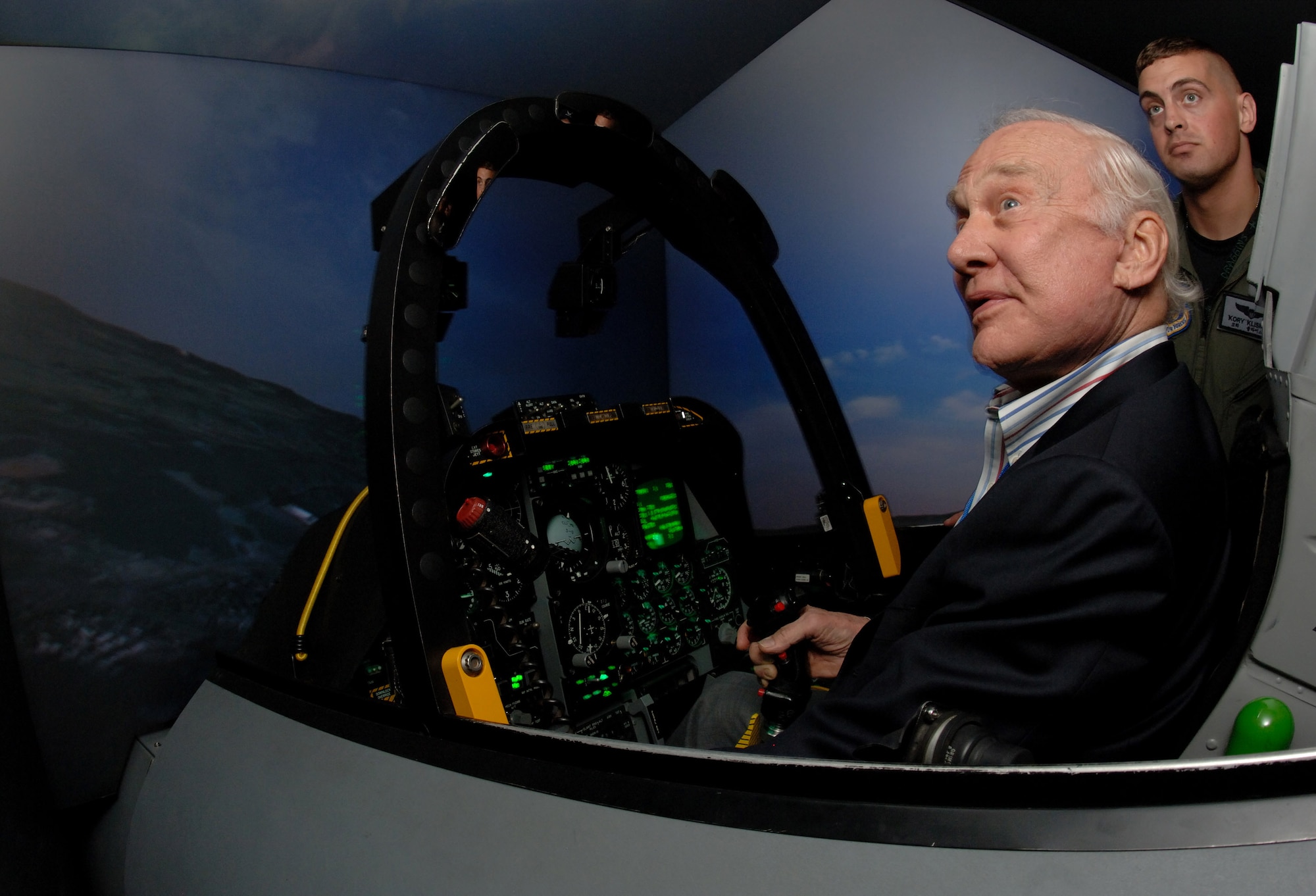 Retired Korean War fighter pilot and Apollo XI astronaut Col. Buzz Aldrin pilots an A-10 Thunderbolt II simulator Sept. 11 while Capt. Kory Klismith observes.  Colonel Aldrin along with seven other Korean War aces was visiting Osan Air Base, South Korea, during a week-long observance of the Air Force's 60th Anniversary.  Captain Klismith is a pilot in the 25th Fighter Squadron.  (U.S. Air Force photo/Staff Sgt. Bennie J. Davis III)