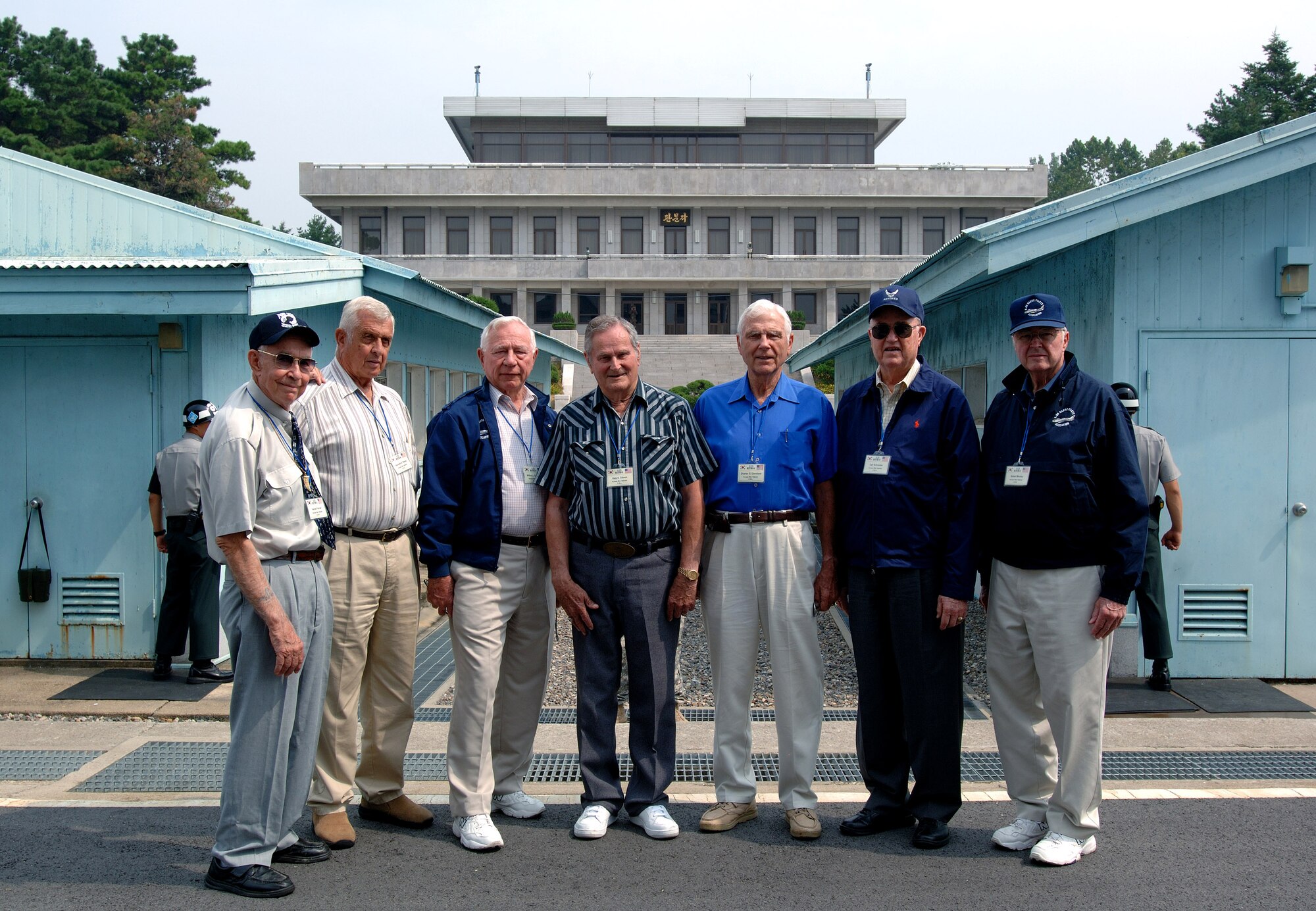 Seven Korean War aces take time for a photo in the Korean Demilitarized Zone during a Sept. 13 tour held to honor Korean War veterans in Panmunjeom, South Korea. The joint security area is the only place where North and South connect. The veterans were visiting South Korea during a weeklong observance of the Air Force's 60th Anniversary. (U.S. Air Force photo/Staff Sgt. Bennie J. Davis III)