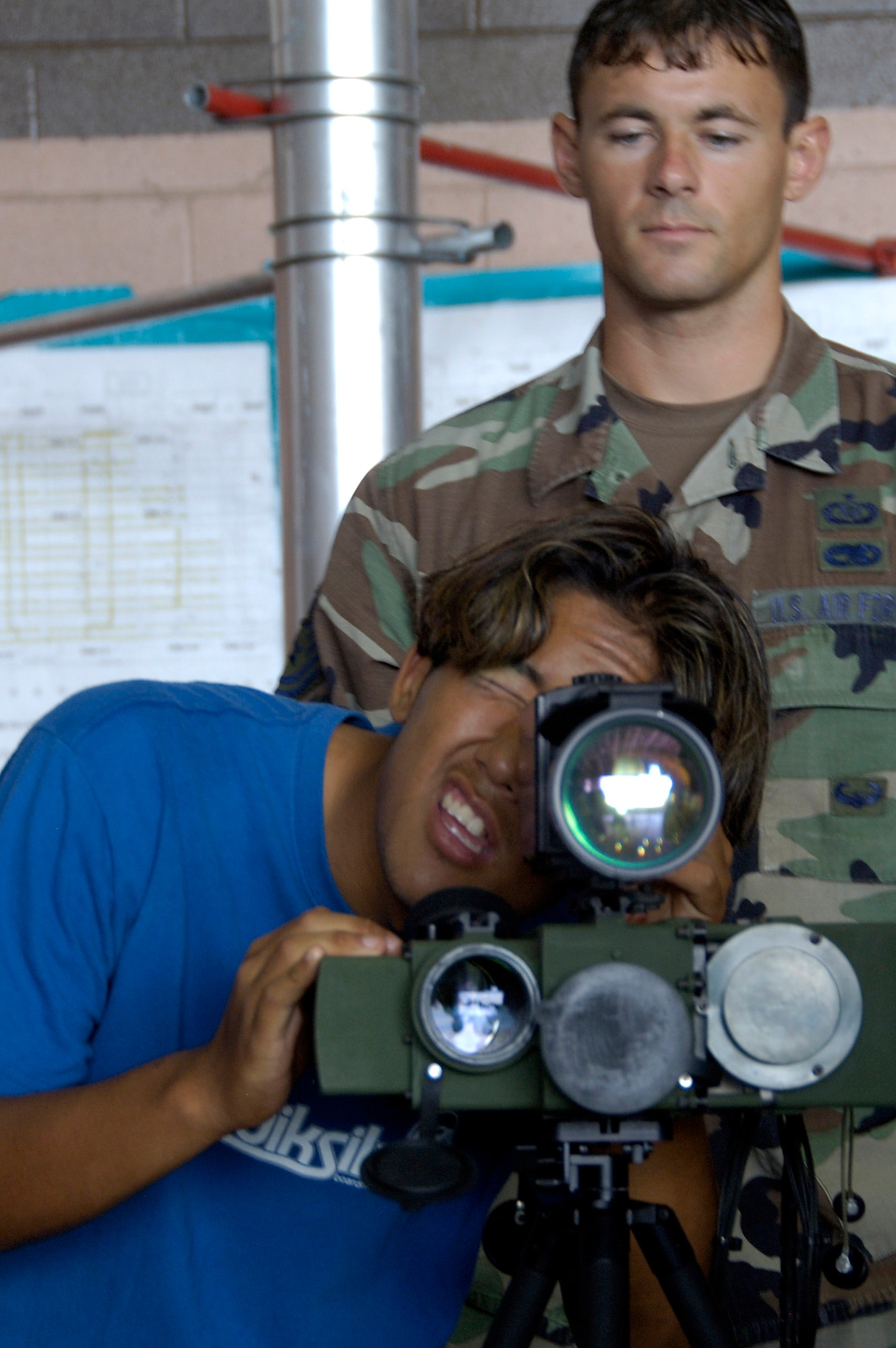 Tech. Sgt. Steve Reedy explains how to operate the laser target designator to Cotton Takaesu during Air Force Education Day at Hickam Air Force Base, Hawaii, Sept. 13.  Members of 13th Air Force hosted the day for Hawaii public school math and science students as part of Air Force Week Honolulu. Sergeant Reedy is with the 25th Air Support Operations Squadron. (U.S. Air Force photo/Staff Sgt. Derrick C. Goode)