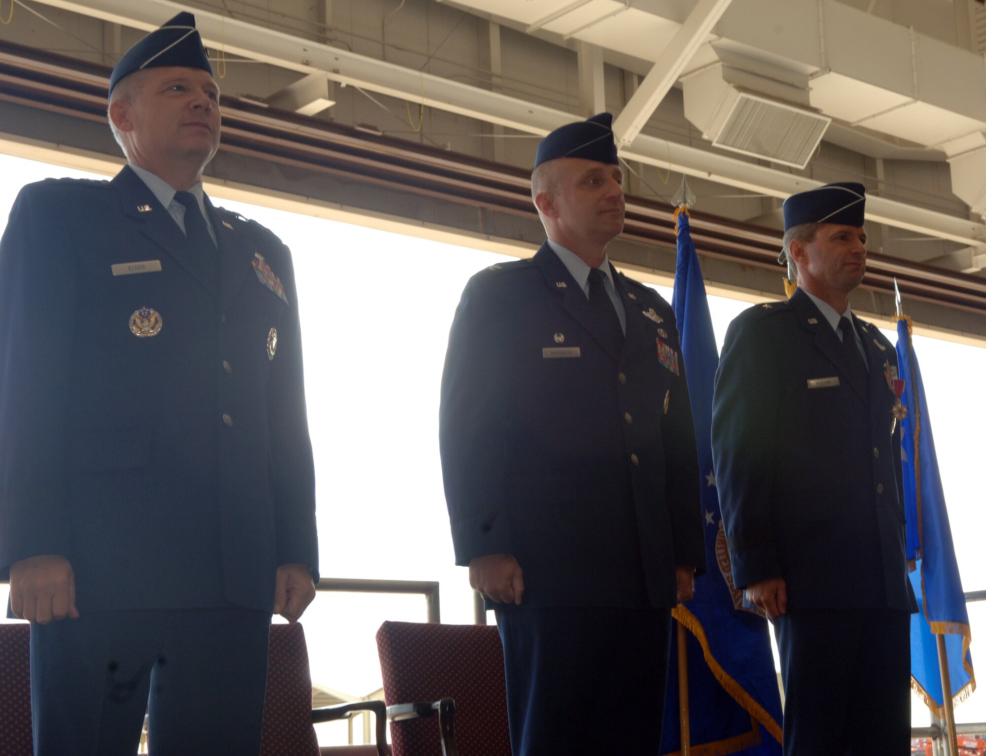 WHITEMAN AIR FORCE BASE, Mo. -- (Left to right) Lt. Gen. Robert Elder Jr., 8th Air Force commander, Col. Garrett Harencak and Brig. Gen. Greg Biscone, stand at attention while the men and women of the 509th Bomb Wing sing the Air Force Song during the 509th Bomb Wing change-of-command ceremony Sept. 14. Colonel Harencak took command of the 509th BW from General Biscone during the ceremony. General Biscone travels to MacDill Air Force Base, Fla., to become the deputy commander of Operations at U.S. Central Command. (U.S. Air Force photo/Staff Sgt. Felicia Haecker)

