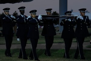LANGLEY AIR FORCE BASE, Va. -- Members of the Langley Air Force Base Honor Guard carry the American flag during a flag folding ceremony at the Air Combat Command Tattoo Sept. 13. This year’s Tattoo celebrated the Air Force’s 60th birthday, and showcased a military tradition that started more than 300 years ago. (U.S. Air Force photo/Airman 1st Class Aaron Johnson)
