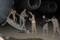 SEYMOUR JOHNSON AFB, N.C.? Airmen from the 4th Fighter Wing load their gear and M-16?s into a C-17 on Sept. 14, 2007 on the flightline at Seymour Johnson AFB. The Airmen are deploying to Southwest Asia in support of the Global War on Terror.  (US Air Force photo by Senior Airman Chad Trujillo)(released)