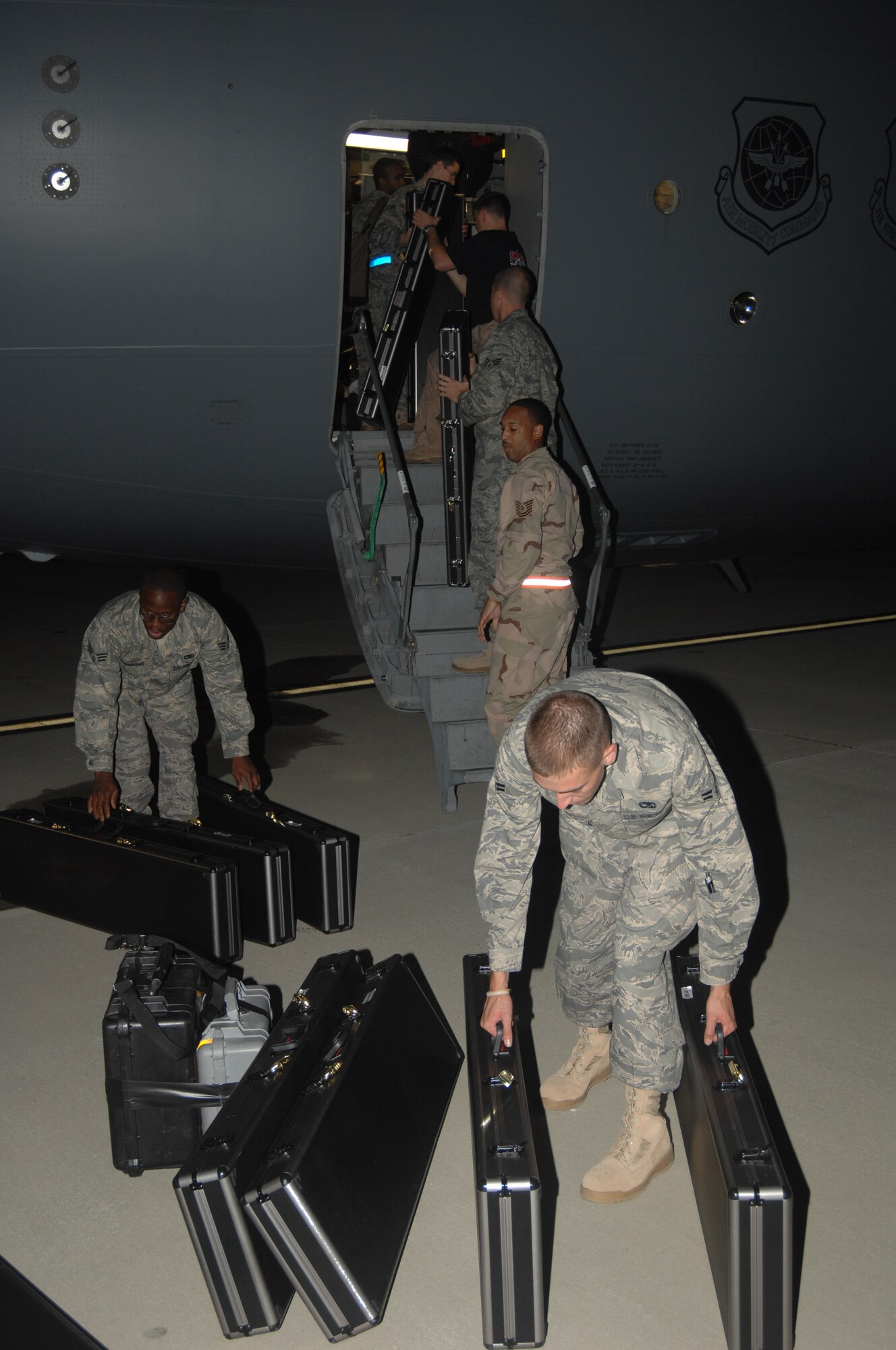 SEYMOUR JOHNSON AIR FORCE BASE, N.C. ? Several Airmen load their weapons and baggage on a C-17 on the flightline at Seymour Johnson AFB, NC.  The Airmen are deploying to Southwest Asia in support of the Global War on Terror.  (US Air Force photo by Senior Airman Chad Trujillo)(released)