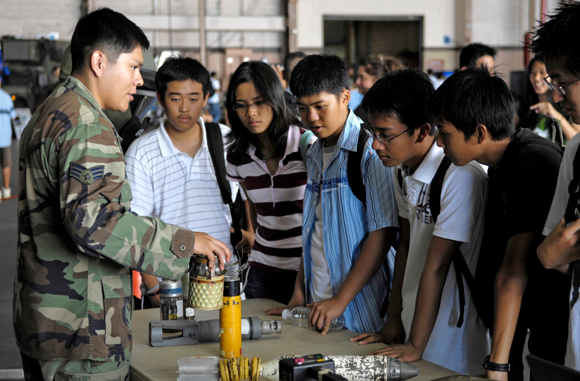 Senior Airman Ryan Ortiz talks to students Sept. 13 at Hickam Air Force Base, Hawaii, during Air Force Education Day. Members of 13th Air Force hosted the day for Hawaii public school math and science students as part of Air Force Week Honolulu. Airman Ortiz is an explosive ordnance disposal technician. (U.S. Air Force photo/Tech. Sgt. Shane A. Cuomo)