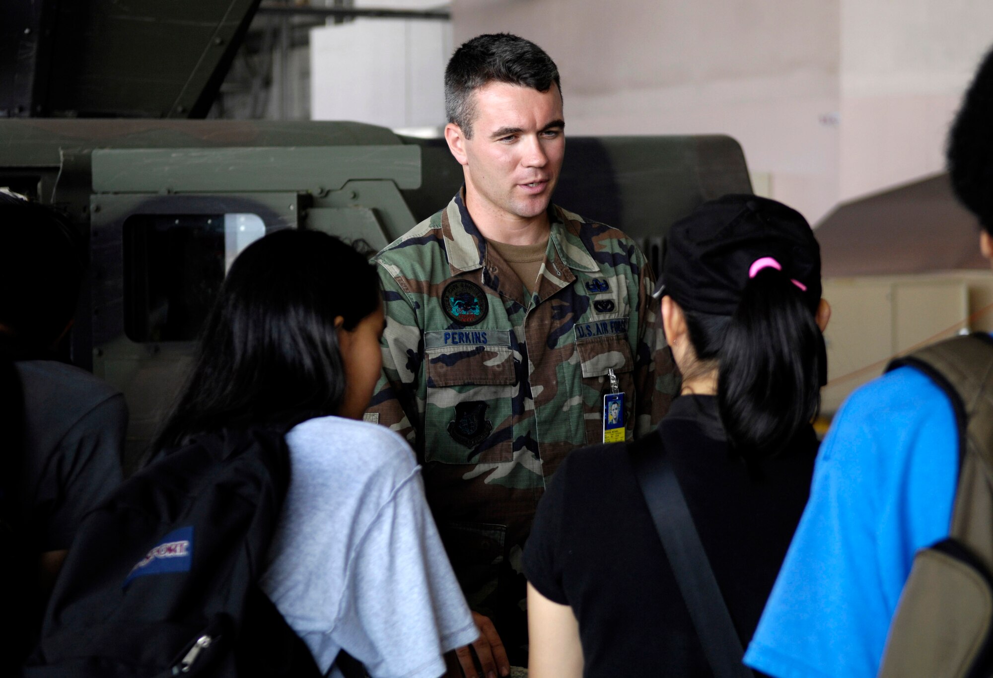 Senior Airman Michael Perkins talks to students Sept. 13 at Hickam Air Force Base, Hawaii during Air Force Education Day. Members of 13th Air Force hosted the day for Hawaii public school math and science students as part of Air Force Week Honolulu. Airman Perkins is an explosive ordnance disposal technician from Hickam. (U.S. Air Force photo/Tech. Sgt. Shane A. Cuomo) 