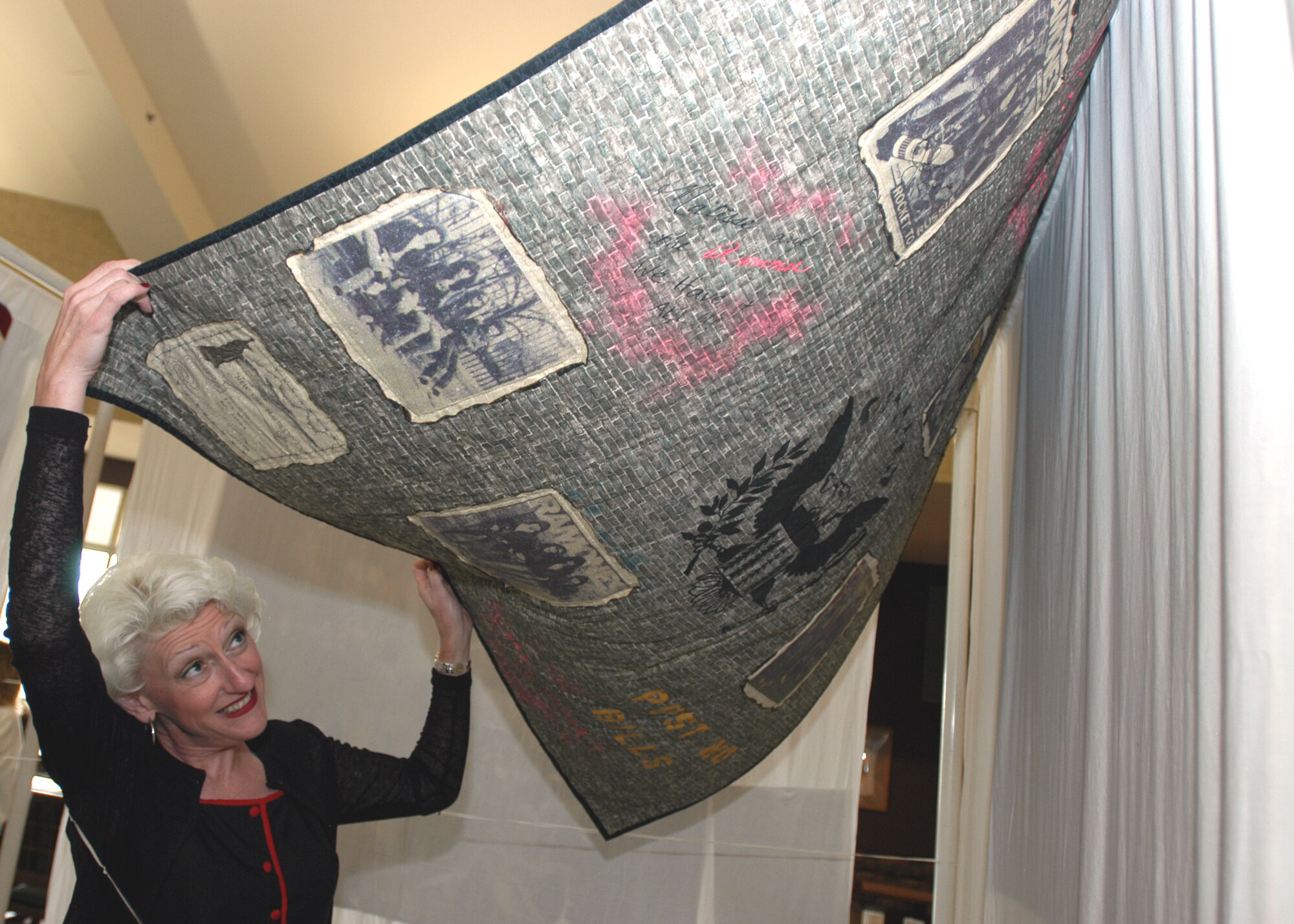 GRISSOM AIR RESERVE BASE, Ind., -- Anne Huskey-Lockard shows the flip side of a quilt she had on display during the family day picnic. She is the wife of Lt. Col. Gary Lockard, chief of public affairs. (U.S. Air Force photo/Staff Sgt. Mark Orders-Woempner)