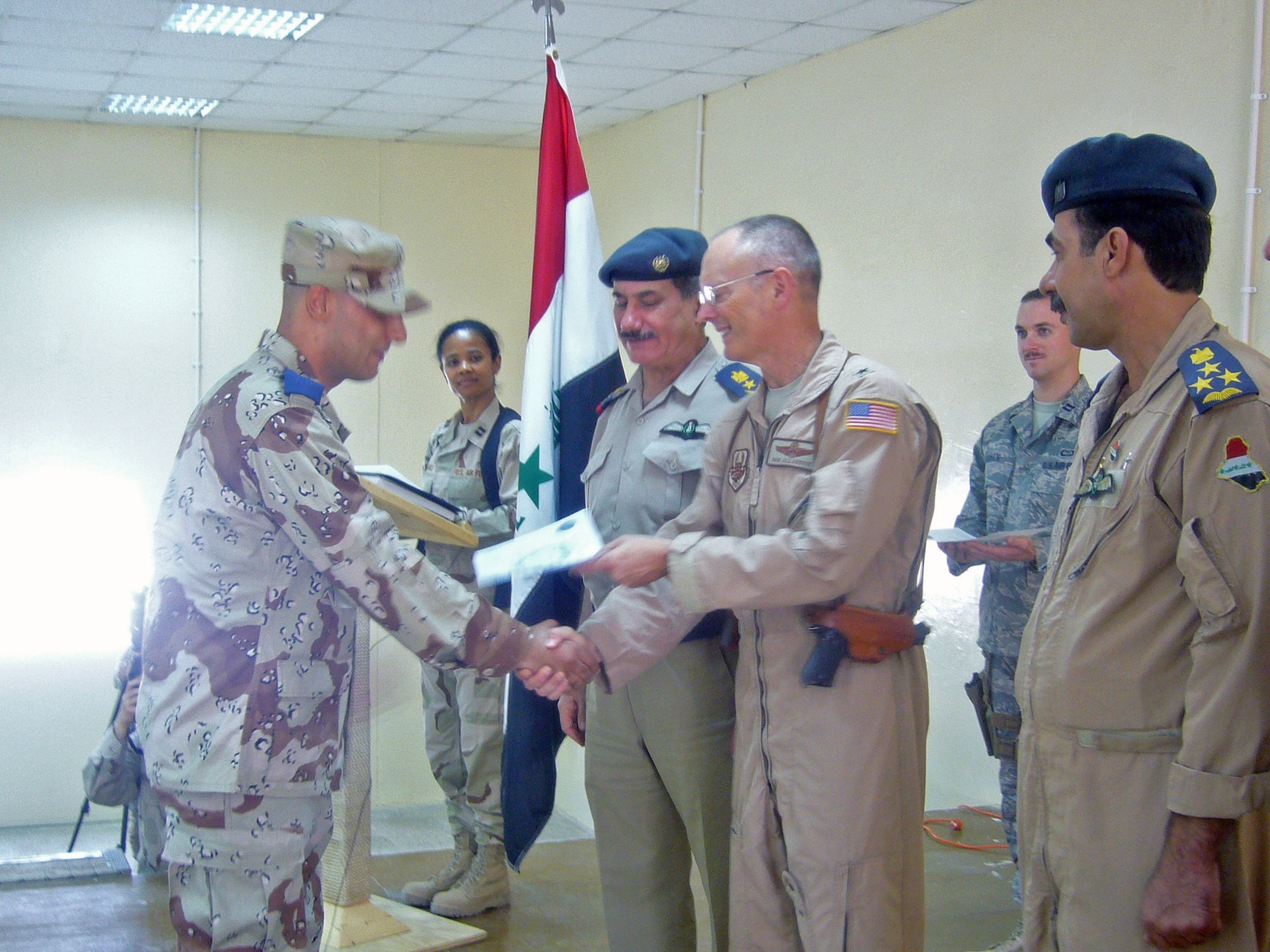 Brig. Gen. Robert R. Allardice (center) takes part in a commissioning ceremony held Sept. 12 following the dedication of the new Iraqi Air Force Training School at Taji Air Base, Iraq.  Also attending are Lt. Gen. Kamal Brazanjay (left), commander of the Iraqi Air Force and (right) the commandant of the Iraqi Air Force Training School. General Allardice is the commander of the Coalition Air Force Transition Team. (U.S. Air Force photo/Maj. Edwina Walton)

