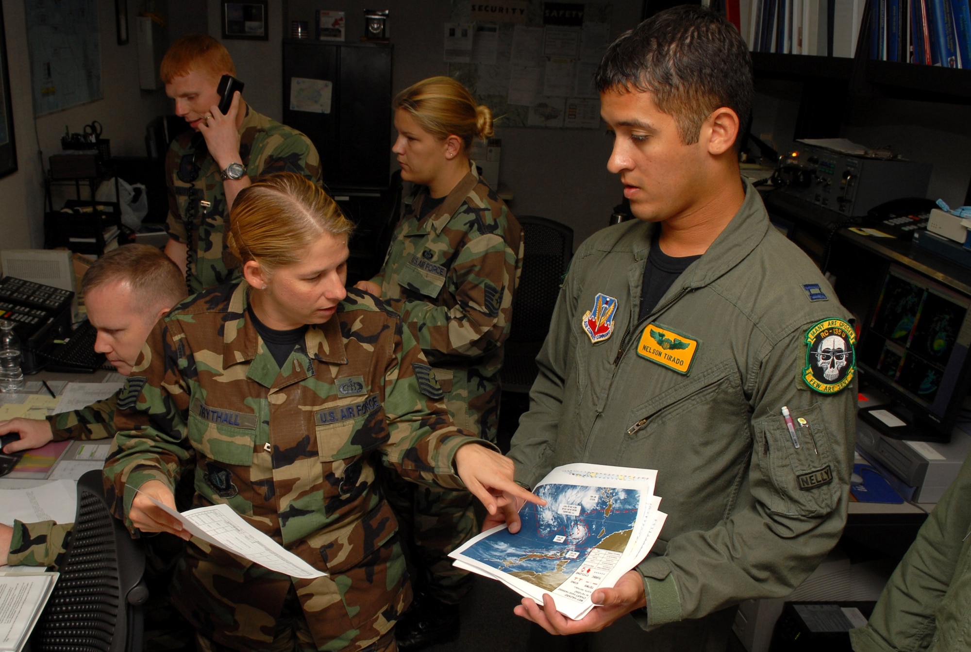 Tech. Sgt. Tonya Trythall shows Capt. Nelson Tirado the storm path of Typhoon Nari path Sept. 14 at Kadena Air Base, Japan. Base members prepared for the typhoon by moving jets and equipment from the flightline into protective aircraft shelters and evacuated many aircraft to locations throughout the Pacific. The typhoon is scheduled to hit the island the evening of Sept. 14 with 45 knot winds gusting to 65 knots. Sergeant Trythall is assigned to the 18th Operations Support Squadron Weather Flight and Captain Tirado is an aircraft commander with the 82nd Reconnaissance Squadron. (U.S. Air Force photo/Junko Kinjo)
