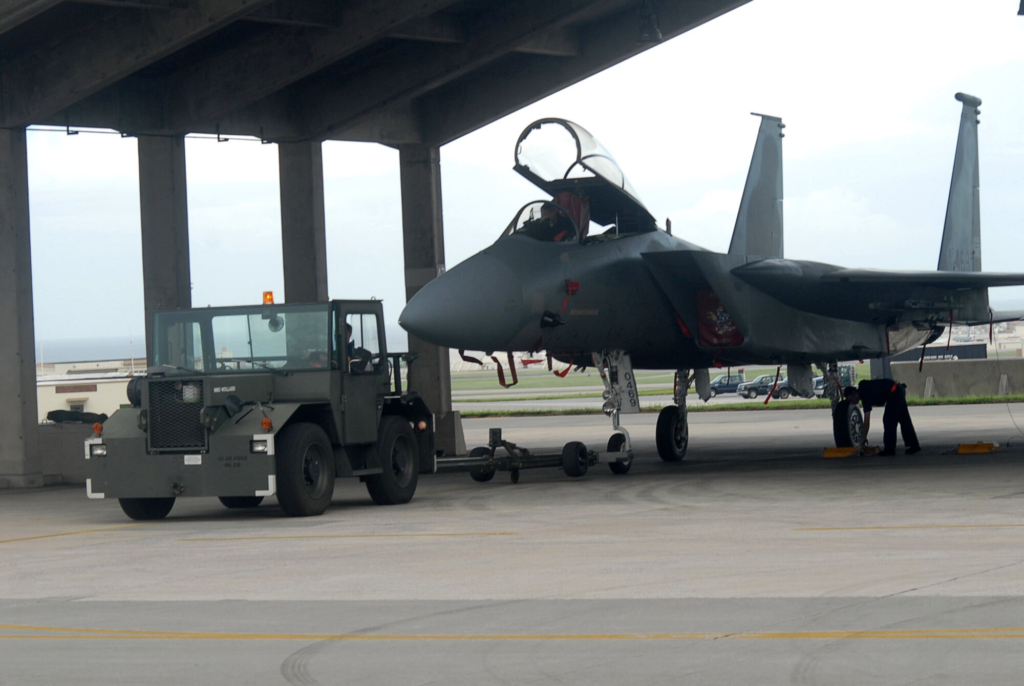 Airmen tow an F-15 Eagle from the flightline into a protective aircraft shelter during preparation for Typhoon Nari Sept. 14 at Kadena Air Base, Japan. Base members prepared for the typhoon by moving jets and equipment from the flightline into protective aircraft shelters and evacuated many aircraft to locations throughout the Pacific. The typhoon is scheduled to hit the island the evening of Sept. 14 with 45 knot winds gusting to 65 knots. (U.S. Air Force photo/Senior Airman Darnell T. Cannady)
