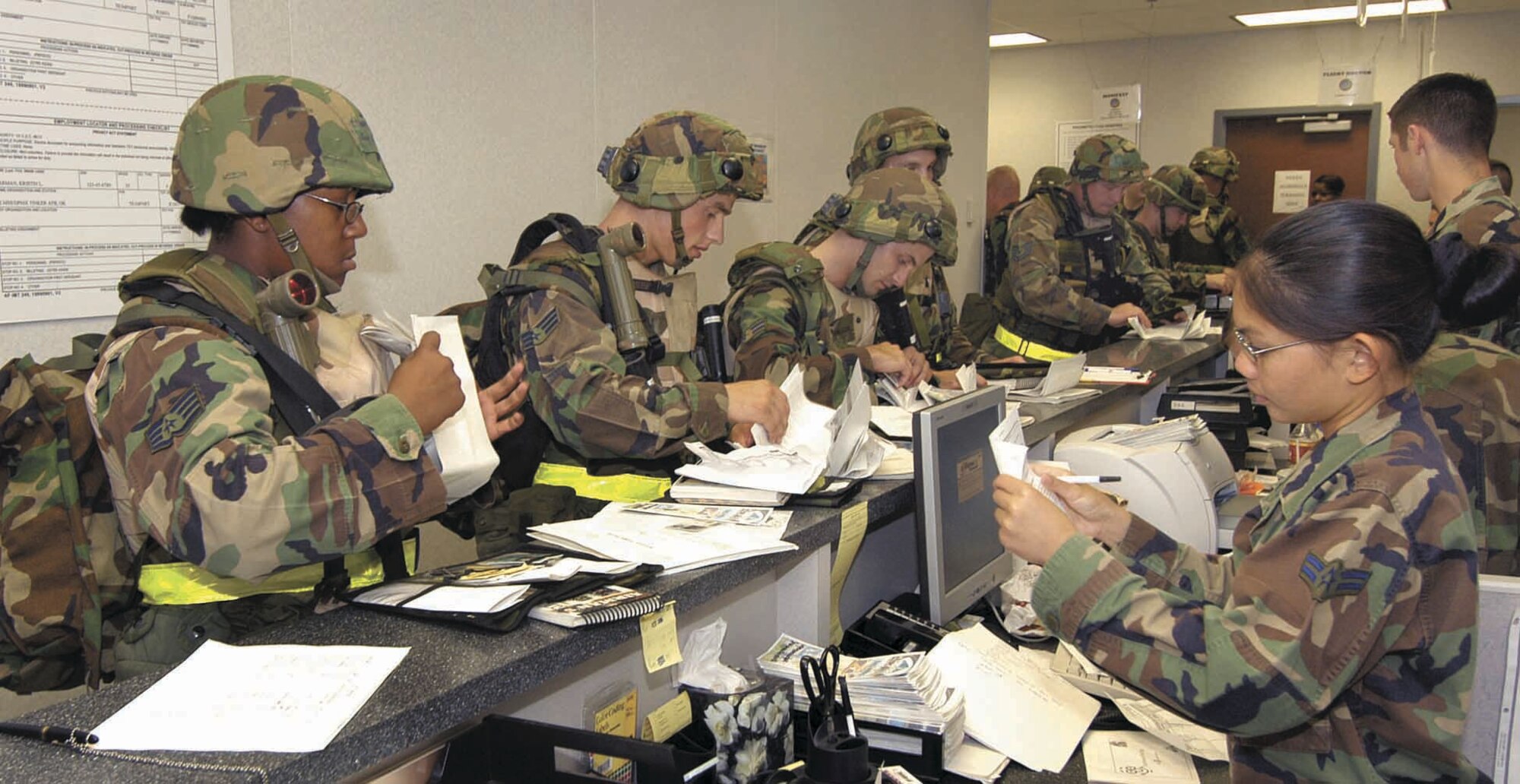 Team Tinker members simulate how they would file through an Operation Readiness Inspection Deployment Processing Line during the ORI Exercise in 2006. (Air Force photo)